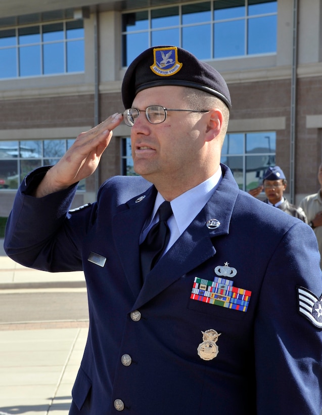 BUCKLEY AIR FORCE BASE, Colo. -- Staff Sgt. Thomas Gehres, 460th Security Forces Squadron, salutes the American Flag during a retreat ceremony for National Police Week May 10. (U.S. Air Force photo by Airman 1st Class Paul Labbe)
