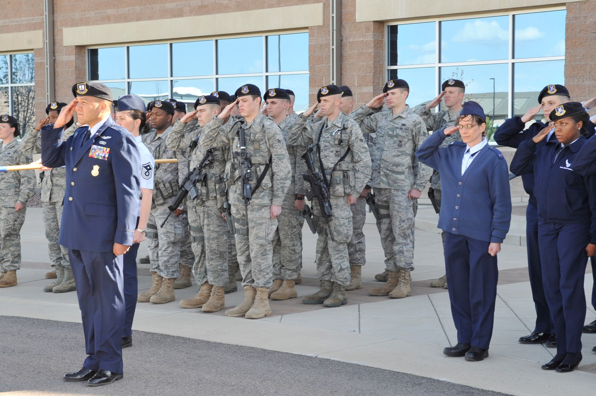 BUCKLEY AIR FORCE BASE, Colo. -- 460th Security Forces Squadron members salute during the National Police Week retreat ceremony May 10. (U.S. Air Force photo by Airman 1st Class Paul Labbe)
