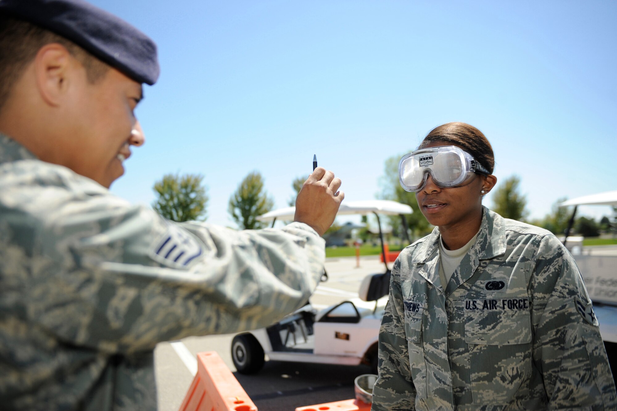 MOUNTAIN HOME AIR FORCE BASE, Idaho -- Airman 1st Class Carla Matthews, 366th Logistic Readiness Squadron material manager, goes through a field sobriety test while wearing beer goggles during a Holt Park demonstration May 13 during National Police Week. The week honors personnel in law enforcement and pays tribute to those who gave their lives while serving their community. (U.S. Air Force photo by Airman 1st Class Renishia Richardson)