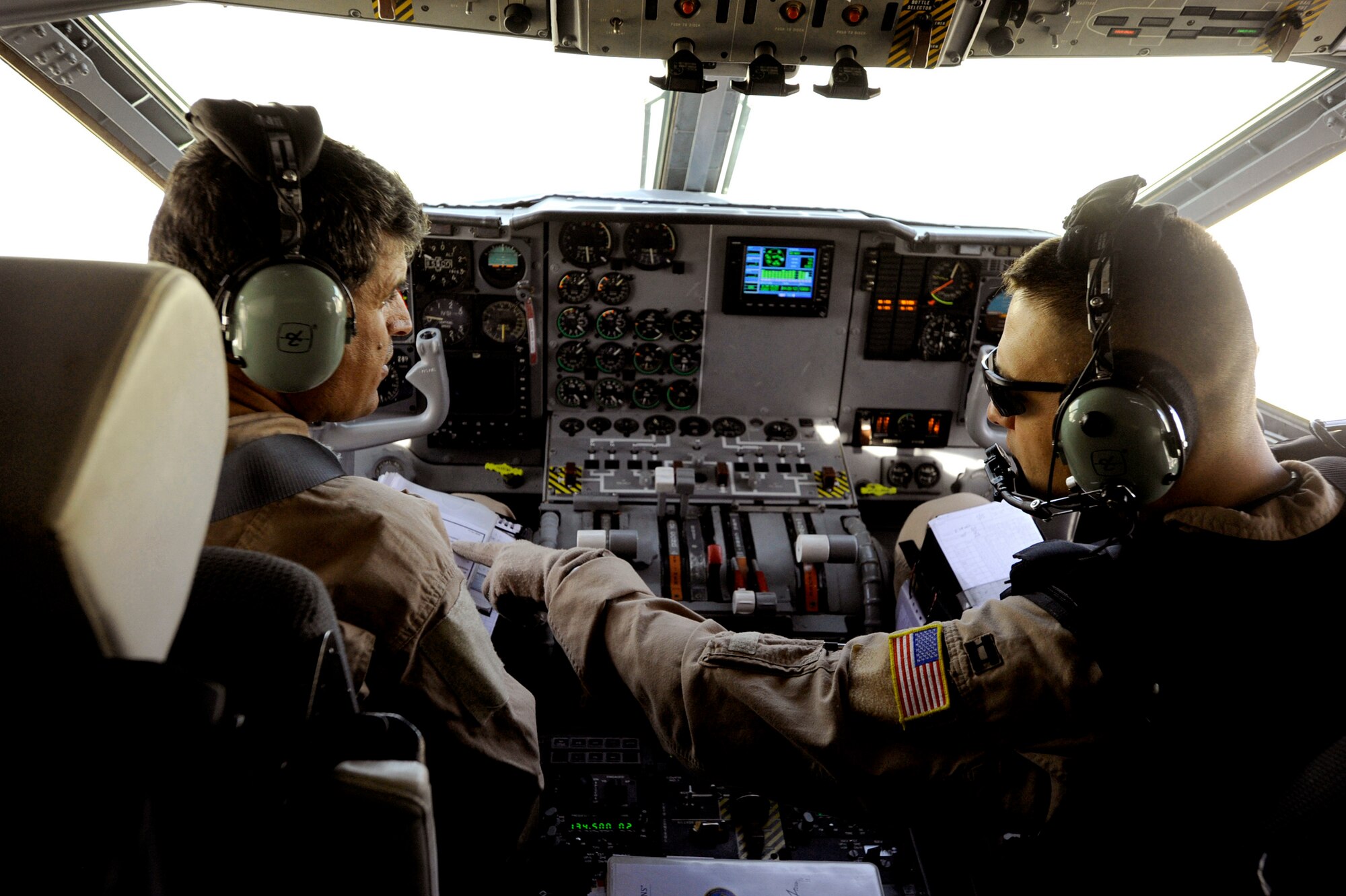 Capt. Larry Needham (right) goes over preflight checklist items with Capt. Mohammad-Shah Ahmadzai prior to takeoff for an operational mission May 15, 2010, at Kabul International Airport, Afghanistan. Since November 2009, Combined Air Power Transition Force Airmen have been training Afghan C-27 Spartan pilots and loadmasters to conduct strategic and tactical airlift, airdrops and presidential support. Captain Needham is a C-27 pilot assigned to the 538th Air Expeditionary Advisory Squadron. Captain Ahmadzai is an Afghan National Army Air Corps C-27 pilot. (U.S. Air Force photo/Staff Sgt. Manuel J. Martinez) 