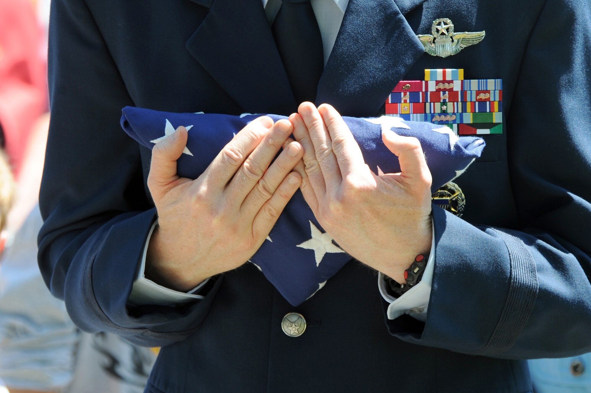 SEDALIA, Mo. - Brig. Gen. Robert Wheeler, 509th Bomb Wing commander, grasps the America flag after the colors were retired during the 2nd Lt. George Whiteman memorial ceremony, Saturday. Many of the local community and family members of 2nd Lt. Whiteman attended the ceremony. (U.S. Air Force photo/Airman 1st Class Carlin Leslie)
 