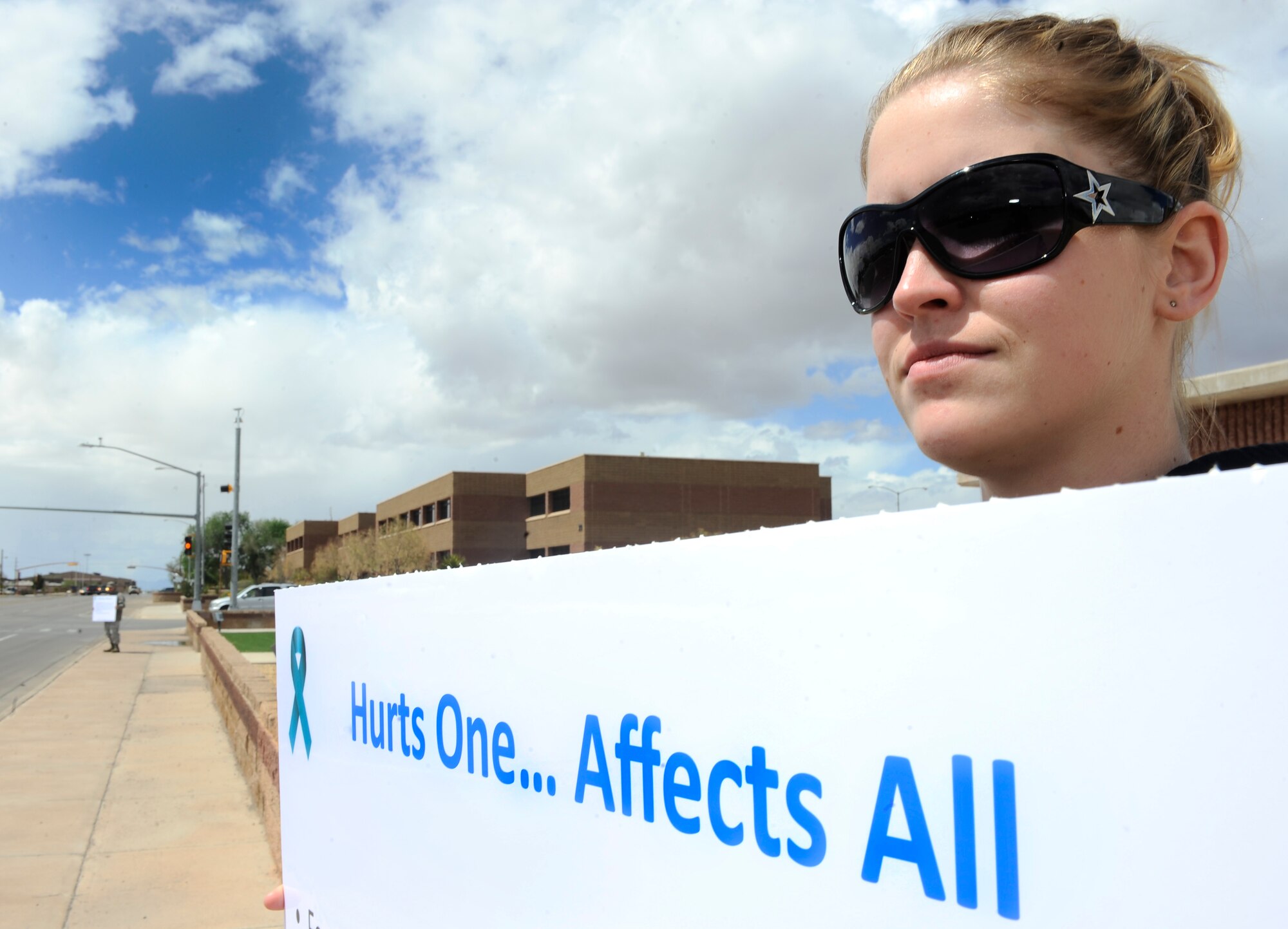 HOLLOMAN AIR FORCE BASE, N.M. -- Airman 1st Class Melissa Smith, 49th Aeromedical Dental Squadron, holds a poster during the Sexual Assault Awareness walk, April 23, 2010. The Sexual Assault Prevention and Response office hosted a walk on First street to support Airmen and their families who have been a victim of sexual assault. (U.S. Air Force photo by Airman 1st Class Veronica Stamps / Released)