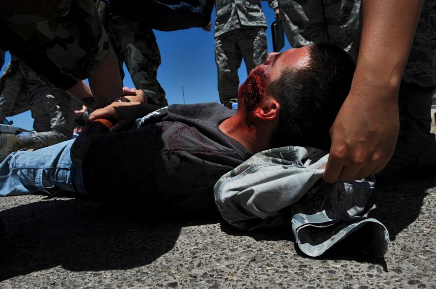 HOLLOMAN AIR FORCE BASE, N.M. -- Airman 1st Class Anthony Armijo, 49th Aircraft Maintenance Squadron, role-plays an injured bystander during a Natural Disaster Exercise May 20, 2010. The exercise scenario involved a grass wildfire which began on state property and spread north to the base. Simulated casualties allowed Holloman Fire and Emergency Services personnel to practice self-aid and buddy care skills in the most realistic manner possible. (U.S. Air Force photo by Airman 1st Class Joshua Turner / Released)