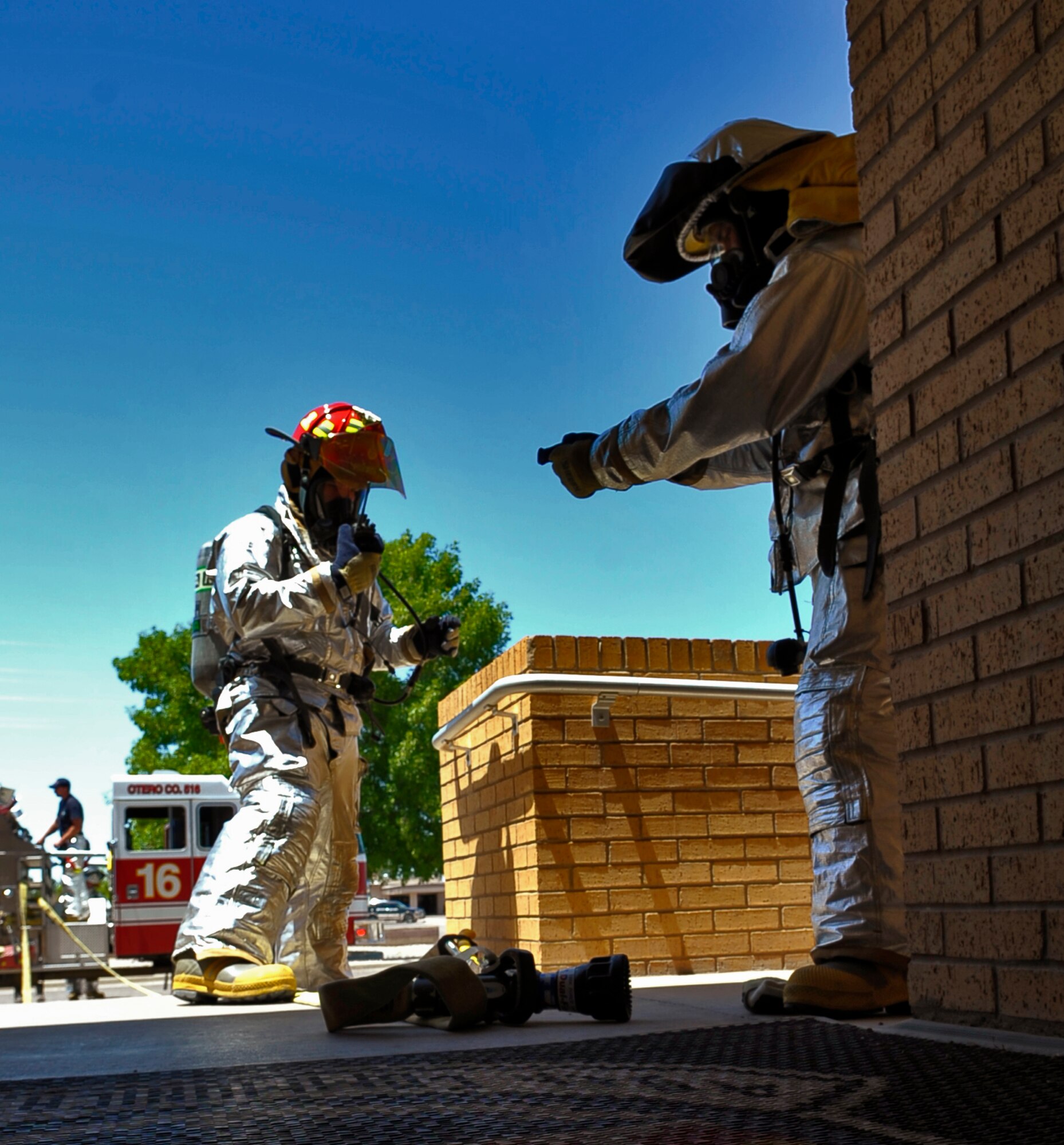 HOLLOMAN AIR FORCE BASE, N.M -- Staff Sgt. David Ordway and Airman Kevin White, 49th Civil Engineer Squadron Fire and Emergency Services, prepare to enter the Network Control Center during a Natural Disaster Exercise May 20, 2010. The exercise began with a simulated grass fire off base which spread on base and ended at the NCC. Otero County emergency services and members of Team Holloman worked together during the exercise scenario as they would during a real world crisis. (U.S. Air Force photo by Airman 1st Class Joshua Turner / Released)