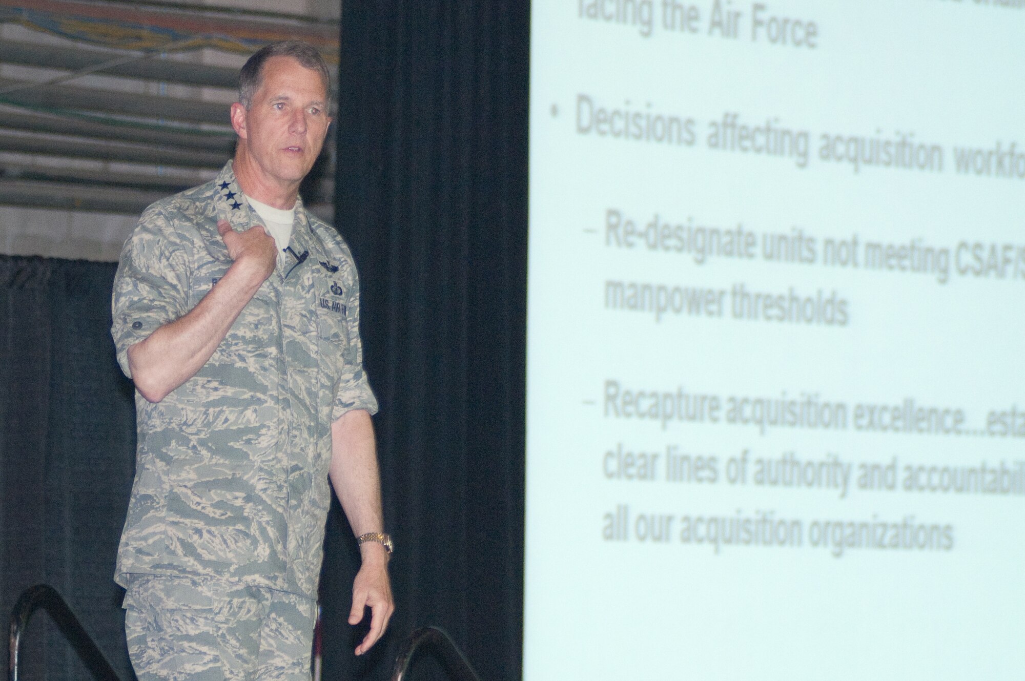 HANSCOM AIR FORCE BASE, Mass – Electronic Systems Center Commander Lt. Gen. Ted Bowlds addresses a capacity audience during his ESC Commander's Call at the Aero Club hangar May 20. General Bowlds discussed the center restructure, his 2010 Commander’s Intent, significant civilian and military personnel issues and the need to maintain a vibrant Wingman culture. (U.S. Air Force photo by Rick Berry)
