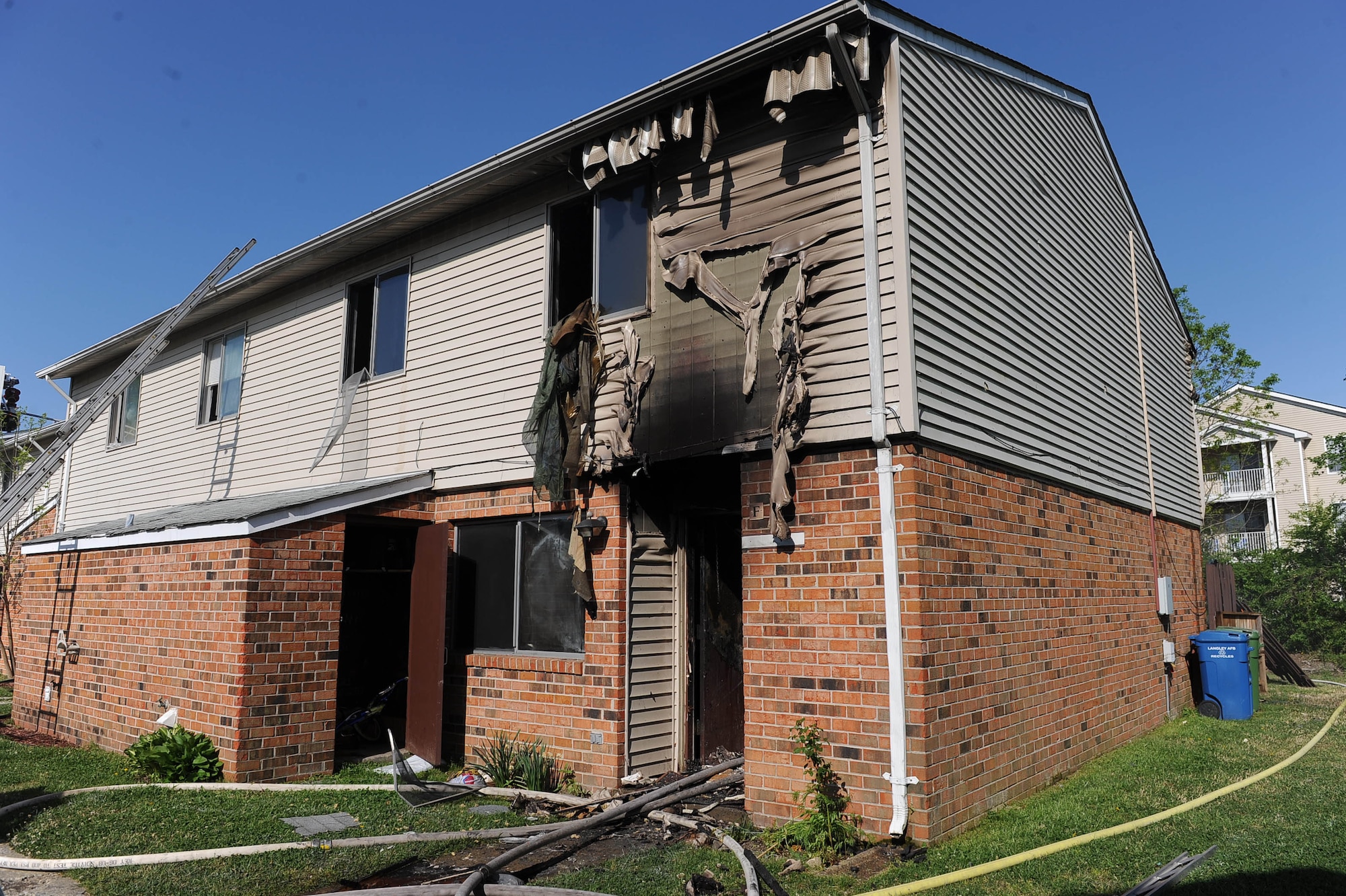 LANGLEY AIR FORCE BASE, Va. -- Fire damage is visible in one of three properties involved in a April 18 fire at the Landings at Langley at Bethel Manor base housing complex. Immediately following the fire, residents, fellow Airmen and local organizations provided food, shelter, household goods and daycare to displaced families, who were relocated to newly-constructed housing within 48 hours. (U.S. Air Force photo/Airman Rebecca Montez)