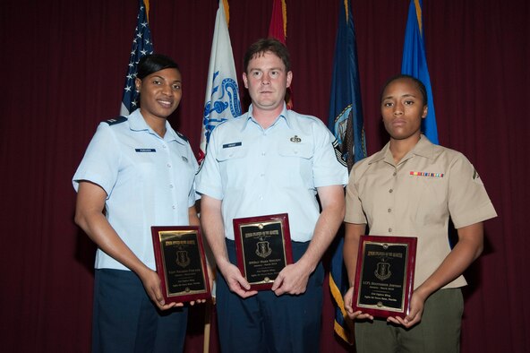 Capt. Natasha Porcher, chief of protocol; Senior Master Sgt. Mark Vincent, 33rd Maintenance Squadronand Lance Corporal Deanndrous Johnson, Marine Fighter Attack Training Squadron 501, display their quarterly awards. Also receiving an award was Tech. Sgt. Kurt Van Wagenen, 33rd Maintenance Group.  This was the wing's first joint service awards ceremony to honor the Wing's quarterly award recipients. (USAF photo) 