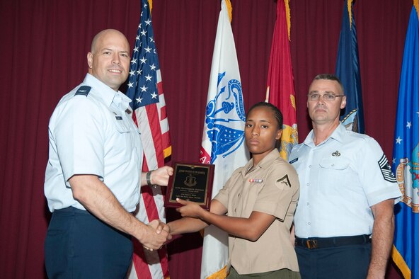 Lance Corporal Deanndrous Johnson, Marine Fighter Attack Training Squadron 501, receives her award from Col. Dave Hlatky, 33rd FW commander and 33rd FW Command Chief Master Sgt. Robert Newman. This was the wing's first joint service awards ceremony to honor the Wing's quarterly award recipients. (USAF photo) 