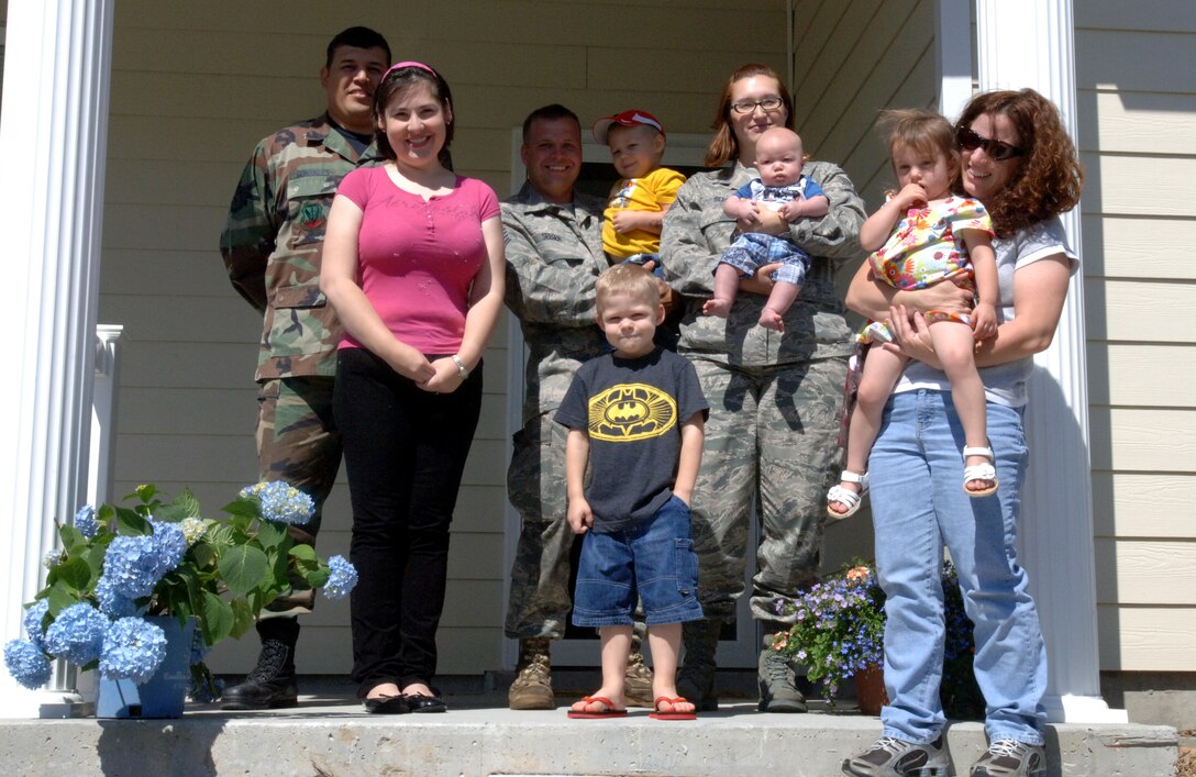 LANGLEY AIR FORCE BASE, Va. -- Family members displaced by an April 18 fire at Bethel Manor stand together on the porch of the Seeger family's new home in the newly-constructed area of Bethel Manor May 7. All three families now live on the same street following the fire, calling their new found friendships a positive outcome of a terrible tragedy. (U.S. Air Force photo/Airman 1st Class Jason J. Brown)