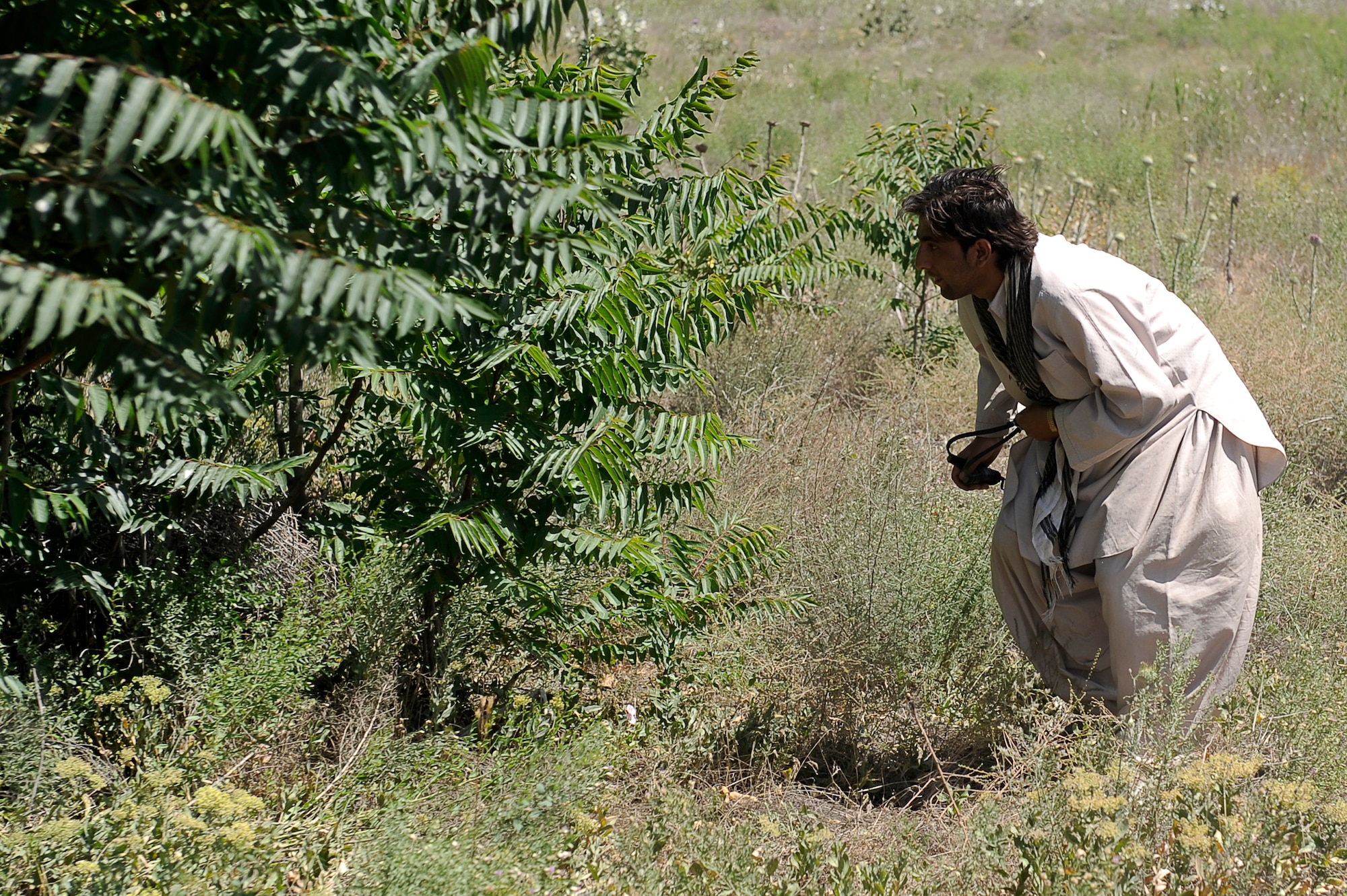 Abdullah a local contractor, hunts for birds with his slingshot near the flight line, May 24, 2010. Afghan contractors work with the 455th Safety Office to keep wildlife from interfering with flying operations at Bagram Airfield, Afghanistan. (U.S. Air Force photo by/ Master Sgt. Jeromy K. Cross/released)








