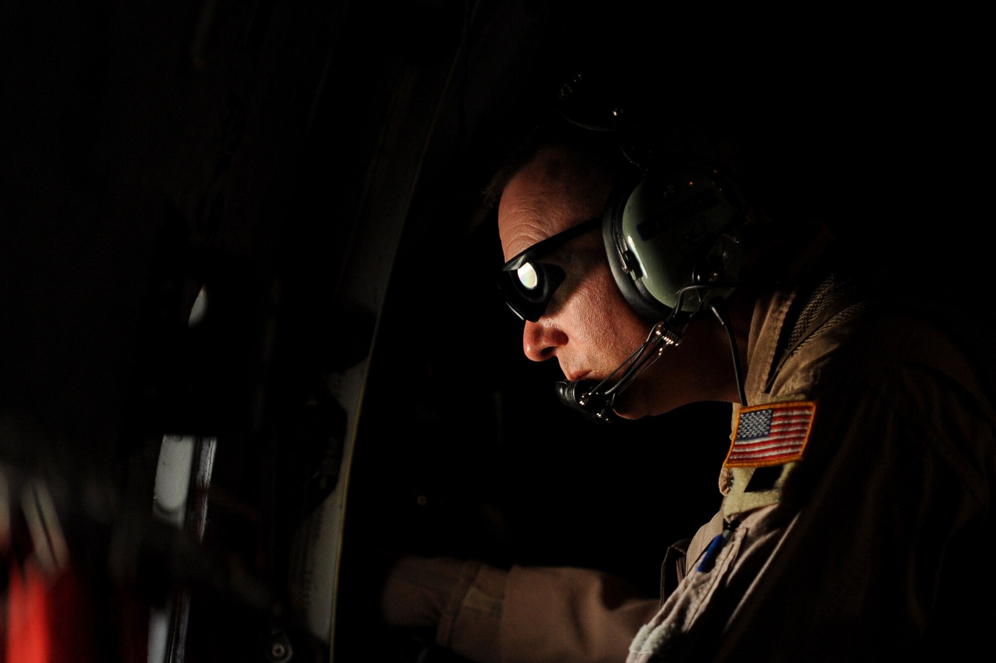Senior Master Sgt. Mike Crews, a C-27J Spartan loadmaster advisor assigned to the 538th Air Expeditionary Advisory Squadron, looks out a window from a C-27 aircraft while enroute to Kandahar Airfield to drop off cargo and pick-up passengers, May 15, 2010.   (U.S. Air Force/ Staff Sgt. Manuel J. Martinez/released)  

