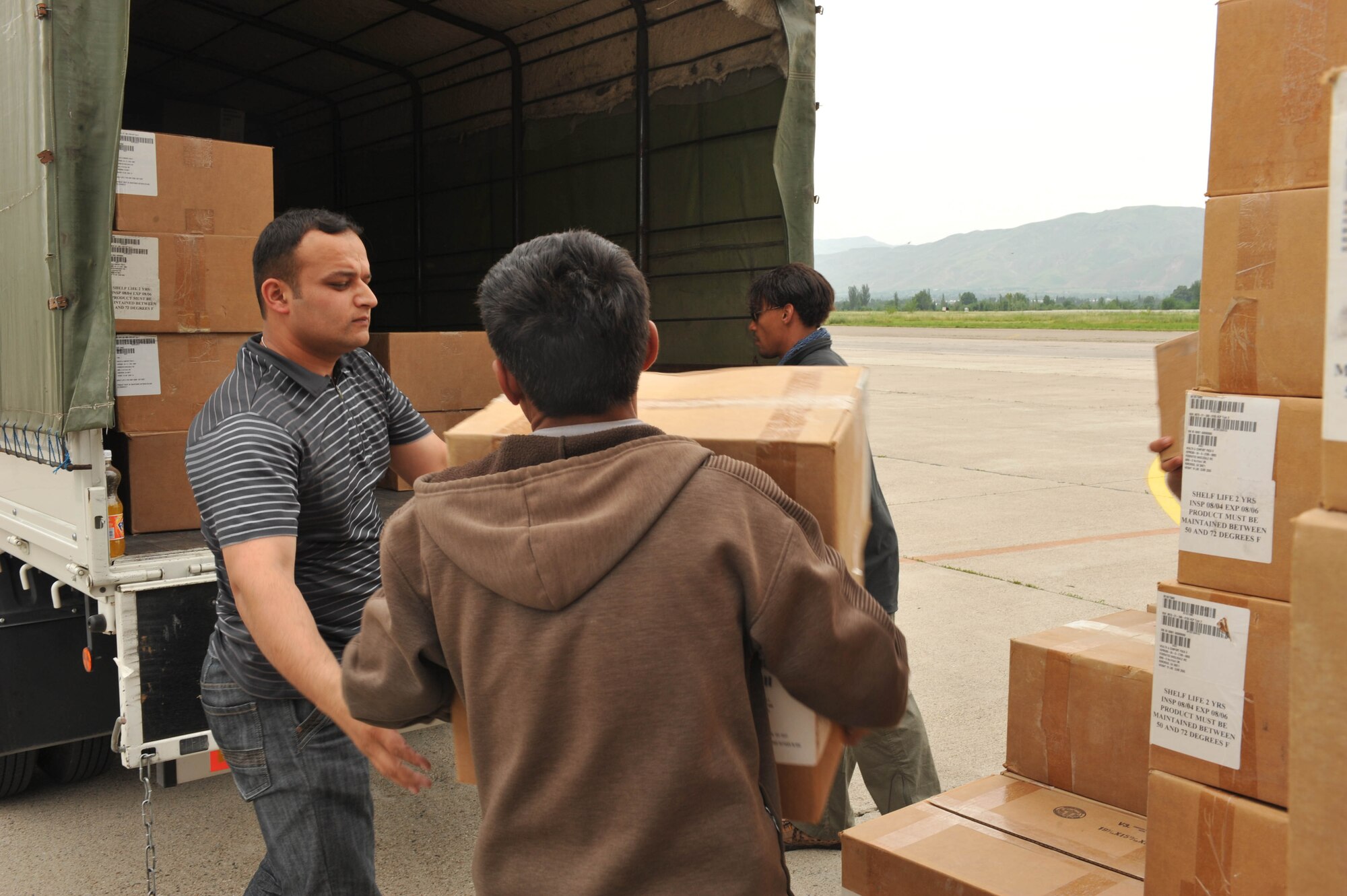 Workers load boxes of medical supplies, hygiene kits and water onto a truck at Dushanbe International Airport, Tajikistan, May 21, 2010. The humanitarian cargo is in support of Tajiks displaced from their homes after floods and mudslides ravaged Kulyab District.  (U.S. Air Force photo/Staff Sgt. Quinton Russ/released)