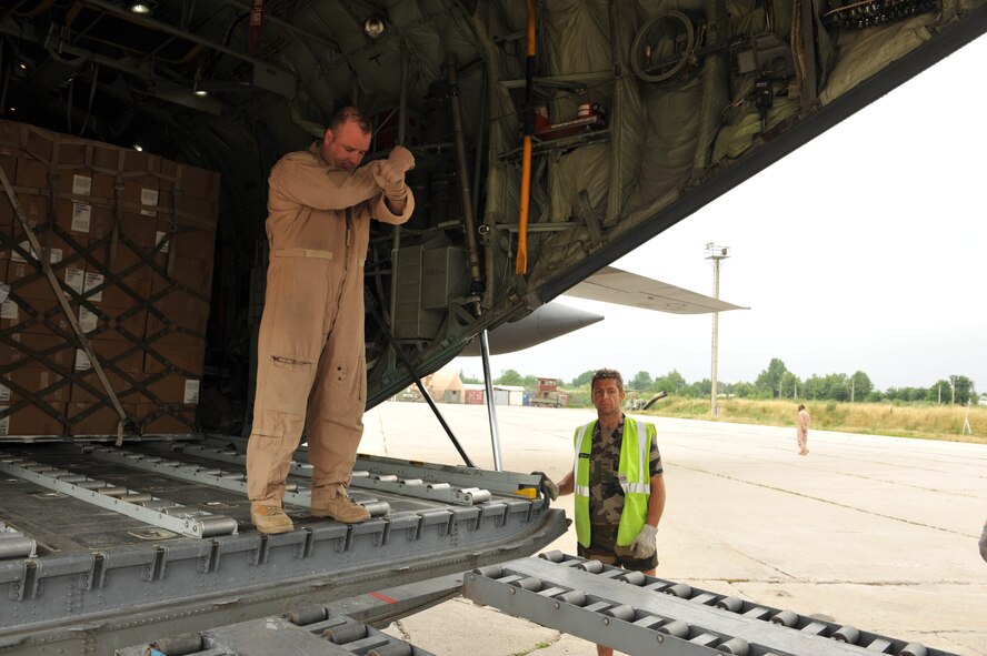 U.S. Air Force loadmaster Master Sgt. Mark Norman guides a forklift to the back of a C-130 Hercules to unload medical supplies, hygiene kits and water for flood victims at Dushanbe International Airport, Tajikistan, May 21, 2010.  Sergeant Norman is deployed to the 774th Expeditionary Airlift Squadron, Bagram Airfield, Afghanistan.   (U.S. Air Force photo/Staff Sgt. Quinton Russ/released)