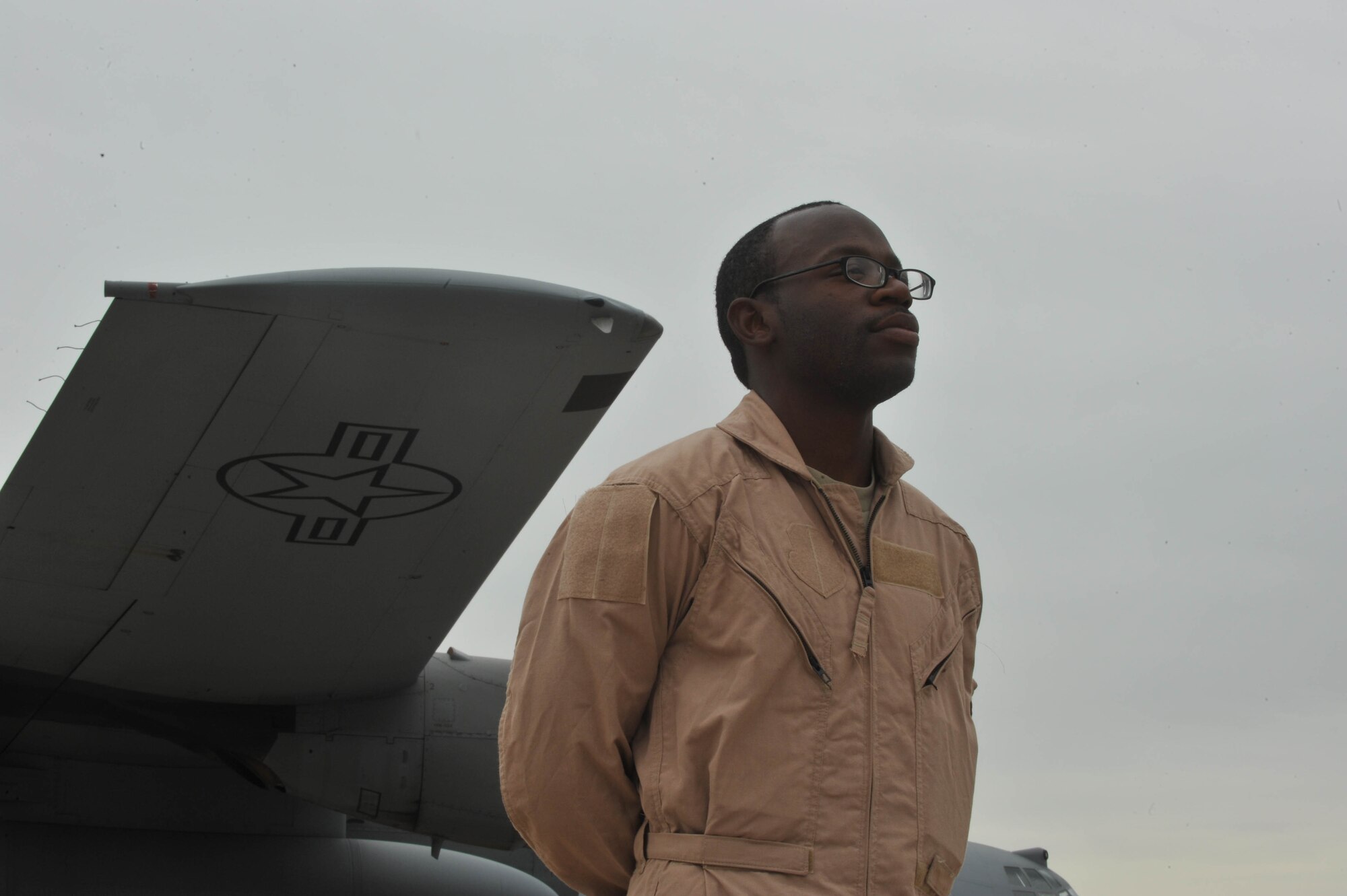 U.S. Air Force security forces member Airman 1st Class DeAndre Buggs stands guard while medical supplies are off-loaded at Dushanbe International Airport, Tajikistan, May 21, 2010.  The humanitarian cargo is for Tajiks displaced from their homes after floods and mudslides ravaged the Kulyab District earlier this month. Airman Buggs is deployed from the 633rd Security Forces Squadron, Langley AFB, VA.  (U.S. Air Force photo/Staff Sgt. Quinton Russ/released)