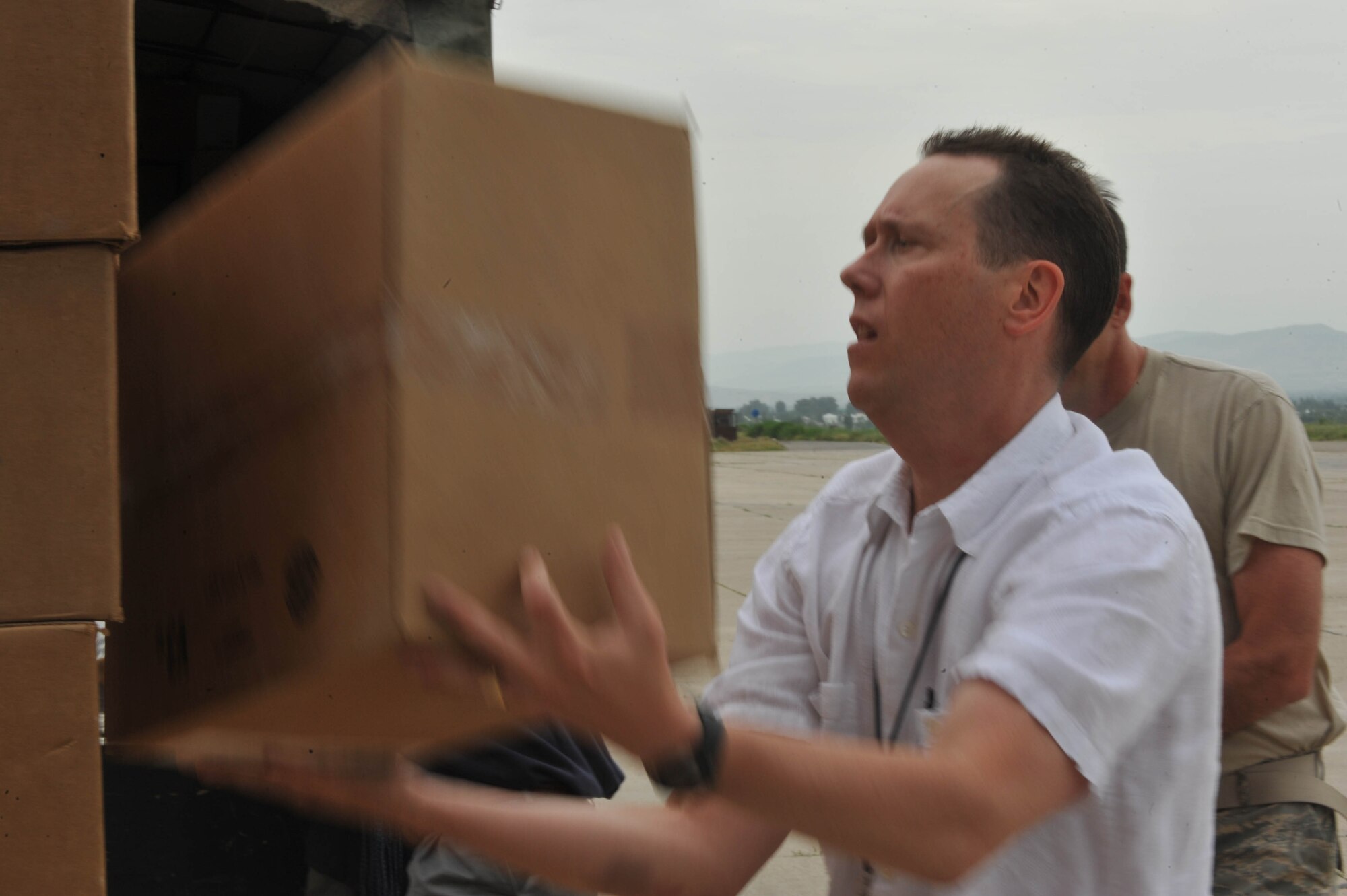 Mr. Kevin Allen helps load boxes of water, hygiene kits and medical supplies at Dushanbe International Airport, Tajikistan, May 21, 2010.  The humanitarian cargo is for displaced Tajiks after floods and mudslides ravaged the Kulyab District earlier this month. Mr. Allen is the general services officer for the U.S. Embassy in Dushanbe.  (U.S. Air Force photo/Staff Sgt. Quinton Russ/released)