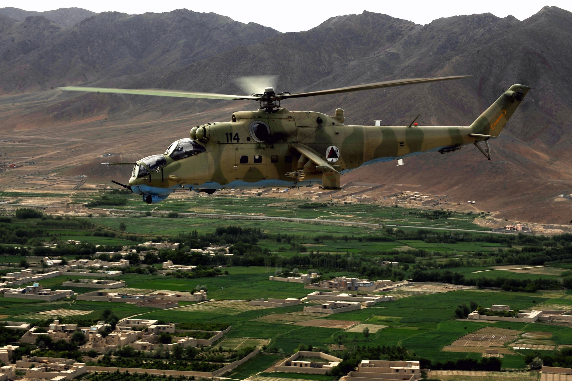 A photo taken from inside an MI-35 Hind E helicopter of another Afghan National Army Air Corps Mi-35 piloted by Hungarian Air Force Maj. Bela Lazar, Hungarian Operational Mentoring Liaison Team commander, and Afghan National Army Air Corps Capt. Gholar Mohaiudin, May 11, 2010, over Afghanistan. "I have a solid mind to be a good pilot, but our advisors have showed us the organizational skills it takes to execute our mission in combat," said Capt. Mohaiudin, who has more than 22 years of experience flying the airframe. "Teaching us to defend our friends in battle and serve our country is something I will always appreciate, we are an asset for the Afghan people and we can be an active part in the defense of our nation." (U.S. Air Force photo/ Staff Sgt. Manuel J. Martinez/released)
