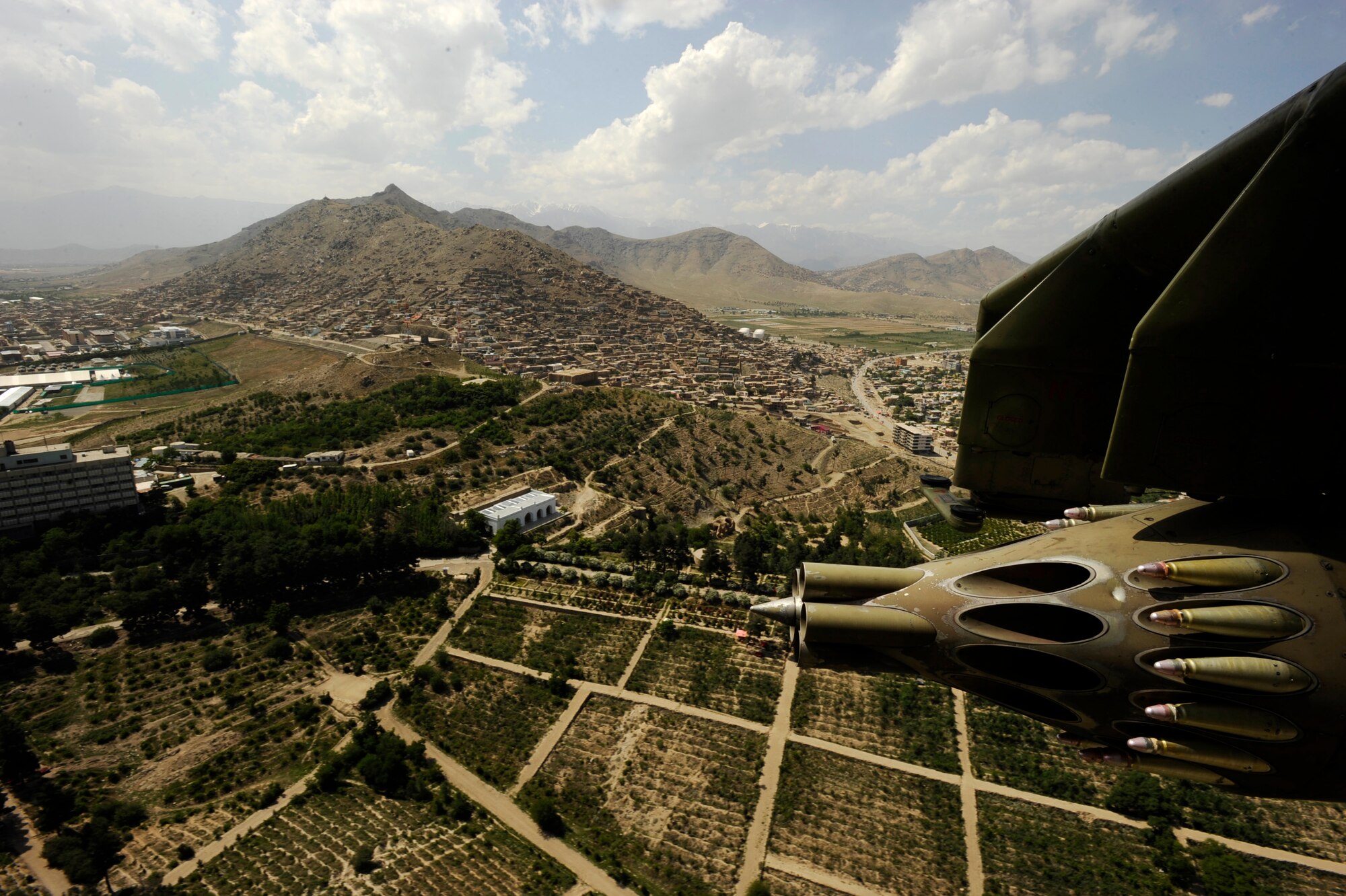 An aerial view from an Afghan National Army Air Corps MI-35 Hind E helicopter piloted by U.S. Air Force Maj. Caleb Nimmo, Mi-35 team lead assigned to the 440th Air Expeditionary Advisor Squadron, and Hungarian Air Force Maj. Szili ''Alex'' Sandor, an Mi-35 Hind E instructor pilot assigned to the Hungarian Operational Mentoring Team May 11, 2010, over Kabul. The joint advisor team currently flies 16 training missions a week. (U.S. Air Force photo/ Staff Sgt. Manuel J. Martinez/released)

