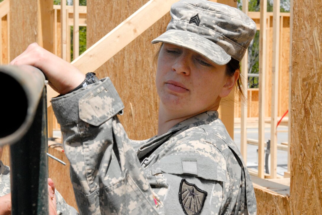 U.S. Army Sgt. Nicole Miller is spending this year's annual training building three cabins at the Disabled Veterans Rest Camp in Marine St. Croix, Minn., May 14, 2010. Miller is assigned to the Minnesota National Guard's 851st Vertical Engineering Company.