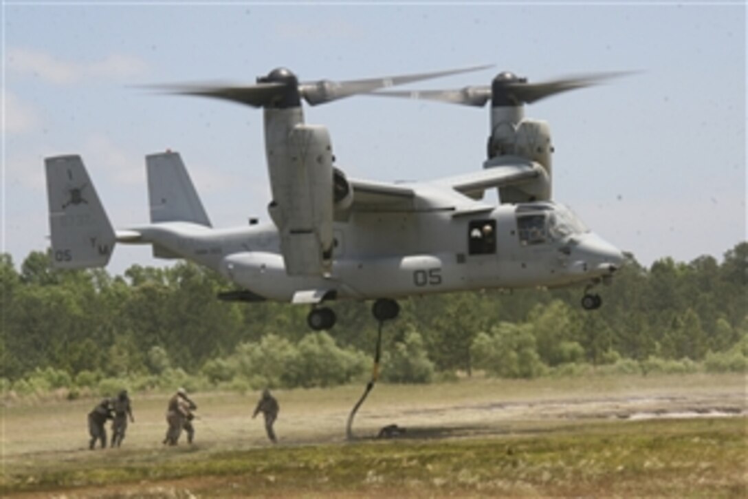 An MV-22B Osprey aircraft exits Landing Zone Condor in North Carolina after conducting a helicopter support team external lift with Logistic Officers Course 10-03, as part of a field exercise known as Operation Blue Devil on May 18, 2010.  The field exercise is designed to give familiarity training to student logistics officers in real world logistics operations.  The five-day exercise consists of day and night convoys, an external helicopter support team lift and rappelling assaults against small attack forces.  