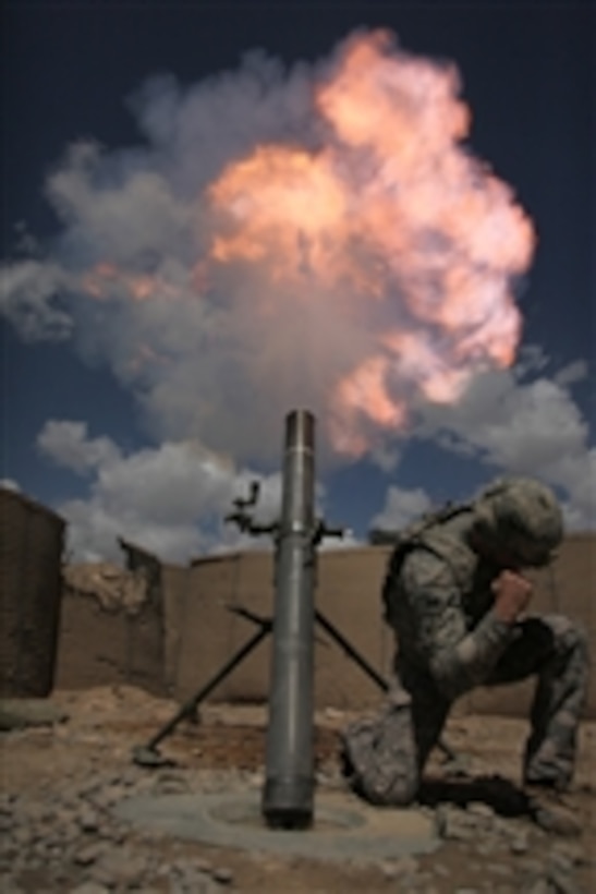 U.S. Army Sgt. Joshua Morris shoots a mortar round from a 120 mm mortar tube during a training and certification test at a combat outpost in Afghanistan on May 18, 2010.  