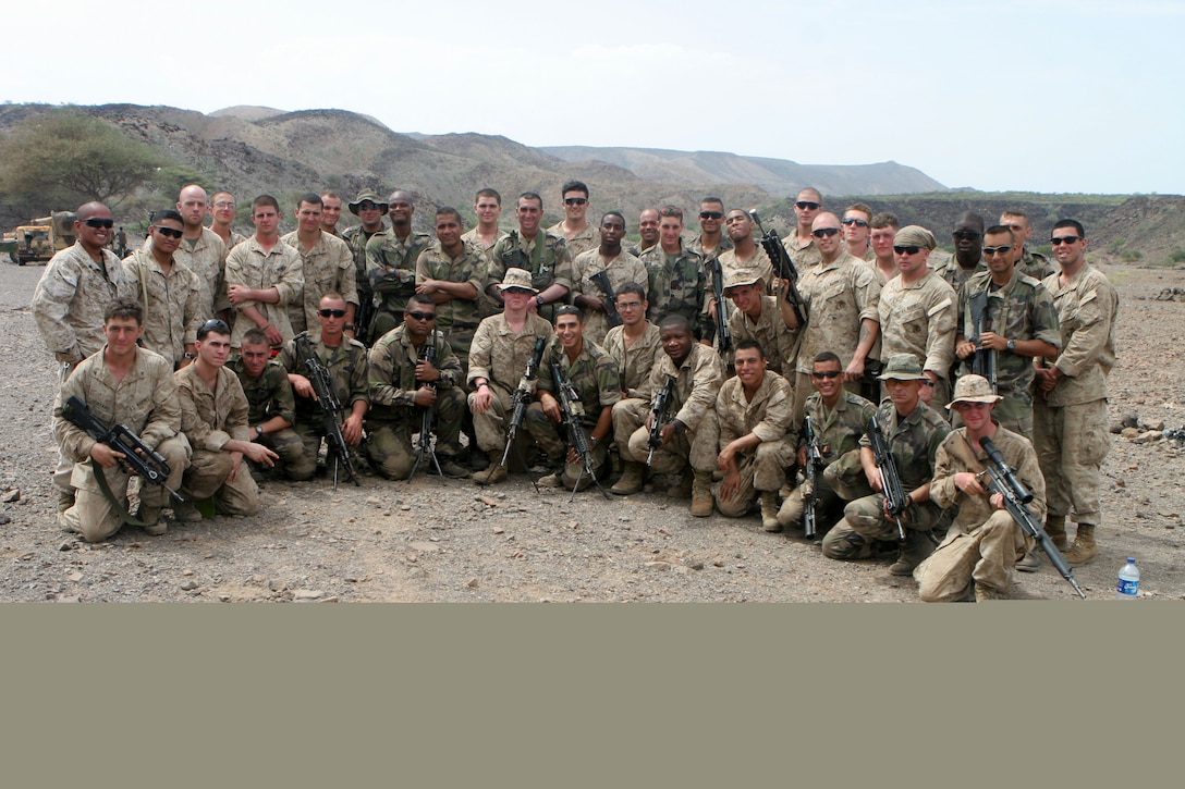 1st Platoon, Charlie Company, Battalion Landing Team 1st Battalion, 9th Marine Regiment poses for a photo with a company of the French Army during a bilateral training exercise in Djibouti, Africa from May 25, 2010.  There has been a continued effort to conduct such exercises between units of the 24th Marine Expeditionary Unit and the French Army during the 24th MEU's deployment to the Central Command area of operations.  The 24th MEU is deployed with the Nassau Amphibious Ready Group as the theater reserve for Central Command. The MEU is an expeditionary force capable of execting a variety of missions from full scale combat operations to humanitarian assistance. (U.S. Marine Corps photo by Lance Cpl. Sean D. Ross.)