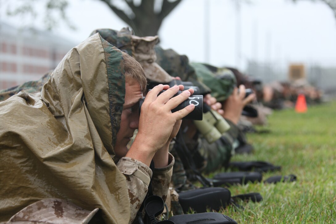Sgt. Colin E. Lafferty, an Amphibious Assault Vehicle crewman with Company A, 2nd Amphibious Assault Vehicle Battalion, looks through a pair of binoculars to spot targets during the Combat Hunter course at the School of Infantry aboard Camp Geiger, N.C. The Combat Hunter course is a five-day and ten-day training exercise, taught regularly at SOI East that trains deploying Marines on the fundamentals of observation, profiling and tracking.