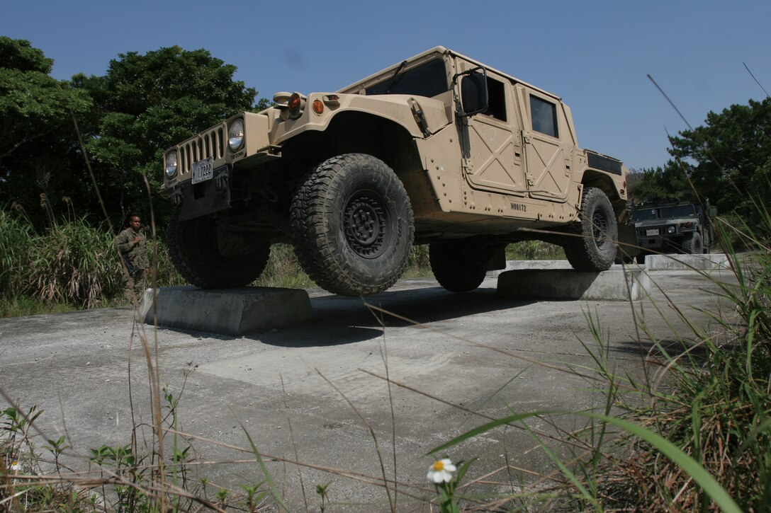A Humvee maneuvers over four concrete blocks during an Advanced Motor Transport Operators Course. Fourteen motor transport mechanics from Motor Transport Company, Marine Wing Support Squadron 172, Marine Wing Support Group 17, 1st Marine Aircraft Wing, III Marine Expeditionary Force, participated in the course.
