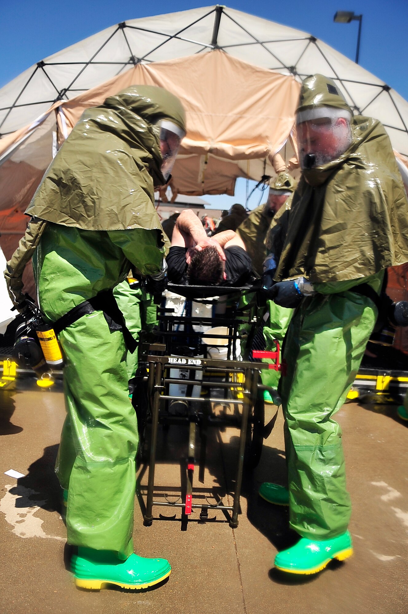 BUCKLEY AIR FORCE BASE, Colo. --  A mock crisis victim is wheeled out of a hazardous-material (HAZMAT) decontamination line May 21. Almost 100 volunteers participated in the All-Hazards Response Training exercise, providing Team Buckley emergency responders with more realistic training for chemical, biological, radiological, nuclear and high-yield explosive incidents. (U.S. Air Force photo by Staff Sgt. Kathrine McDowell)