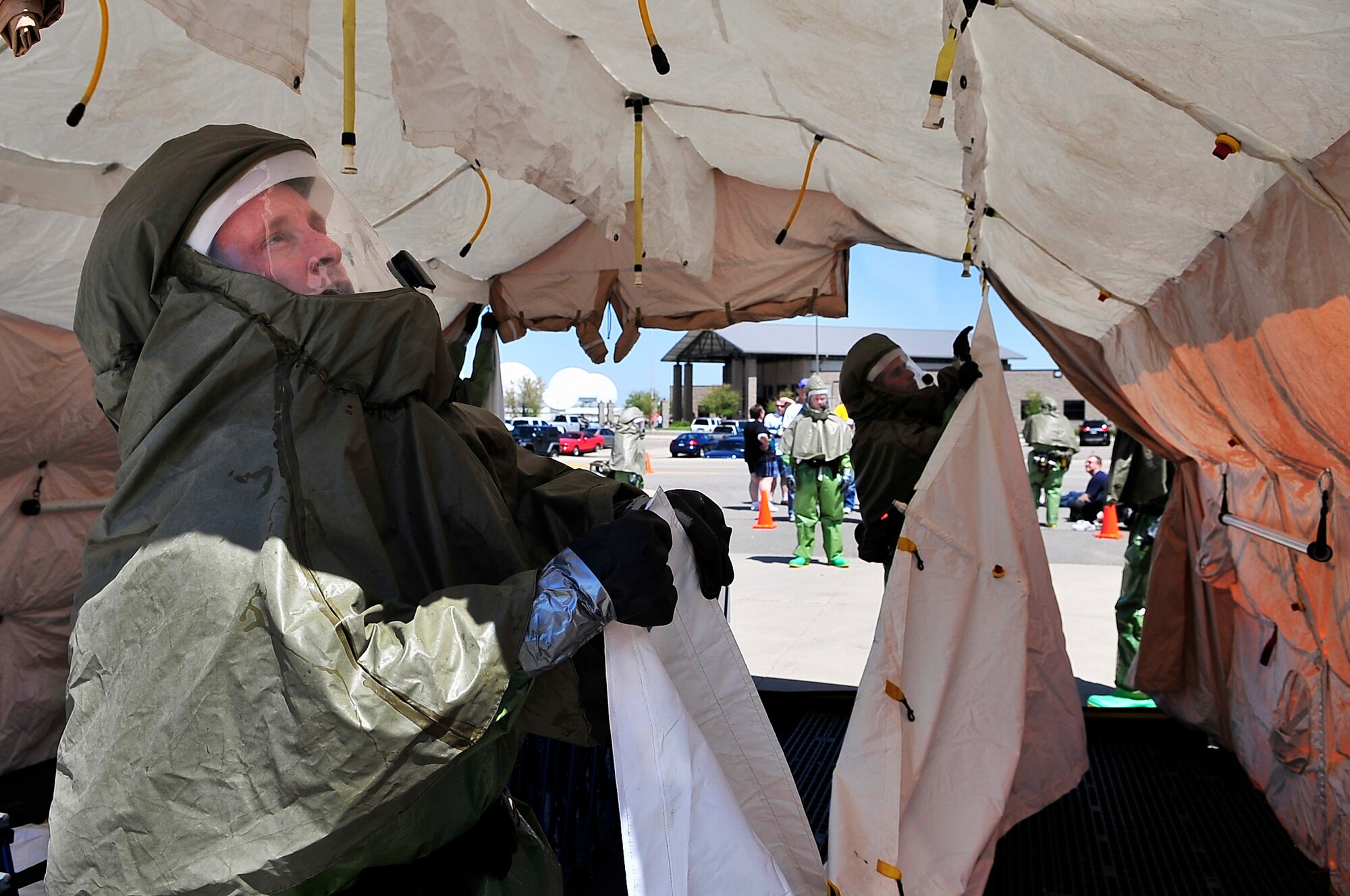 BUCKLEY AIR FORCE BASE, Colo. --  Major Jon Ehrenfried and 1st. Lt.  Matthew Bussa, both of the 460th Medical Operations Squadron, set up a hazardous-material decontamination line during an All- Hazards Response Training exercise May 21. 460th Medical Group emergency response teams treated mock casualties of a chemical, biological, radiological, nuclear and high-yield explosive (CBRNE) scenario. (U.S. Air Force photo by Staff Sgt. Kathrine McDowell)