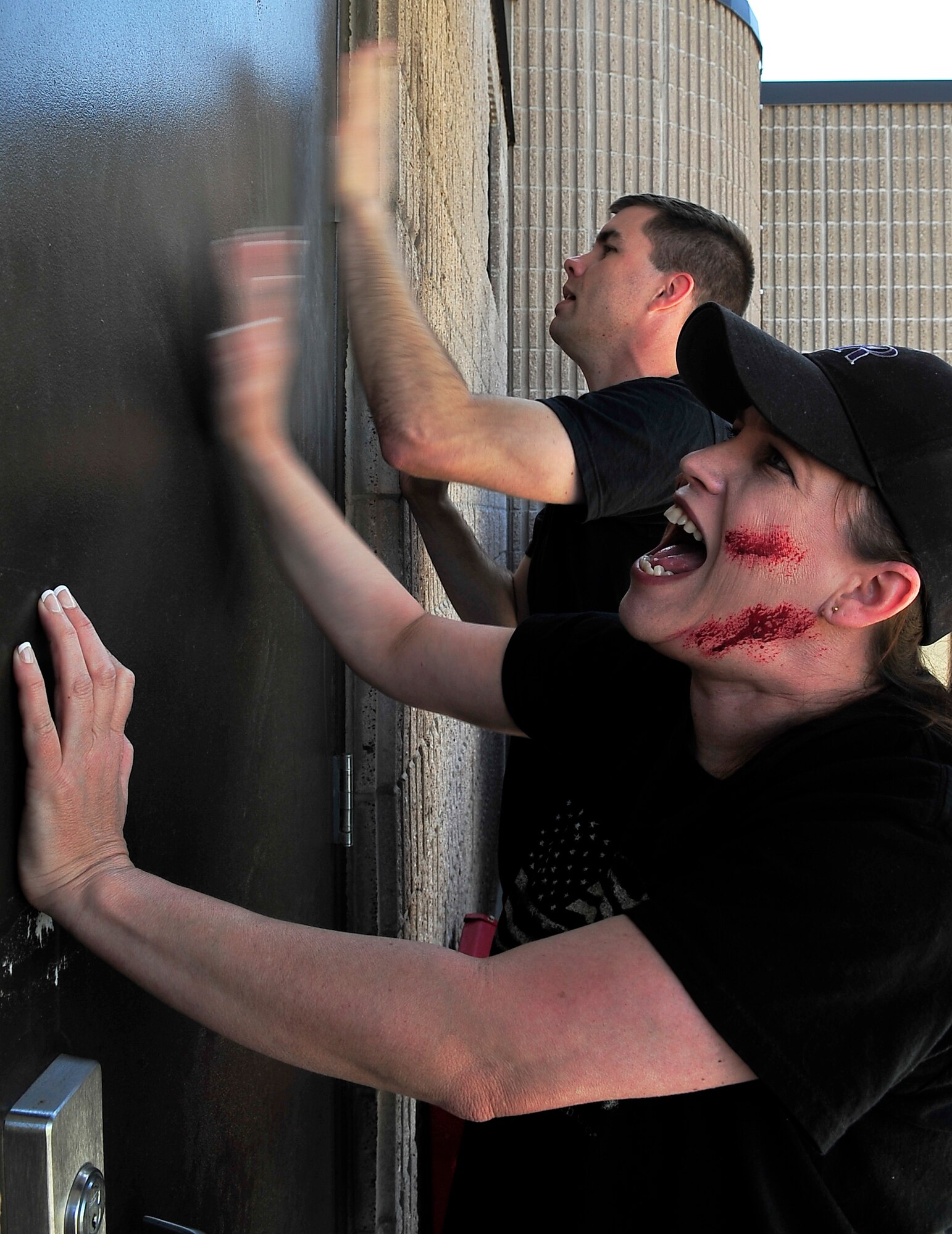 BUCKLEY AIR FORCE BASE, Colo. -- Staff Sgts. Melody Tucker and Charles Rice, 460th Space Communications Squadron and 2nd Space Warning Squadron, respectively, cry for help during an All-Hazards Response Training exercise May 21. The sergeants acted as mock victims of a terrorist attack. The exercise helps train emergency response teams in assessing in the safe, proper and quick treatment of crisis victims.  (U.S. Air Force photo by Staff Sgt. Kathrine McDowell)