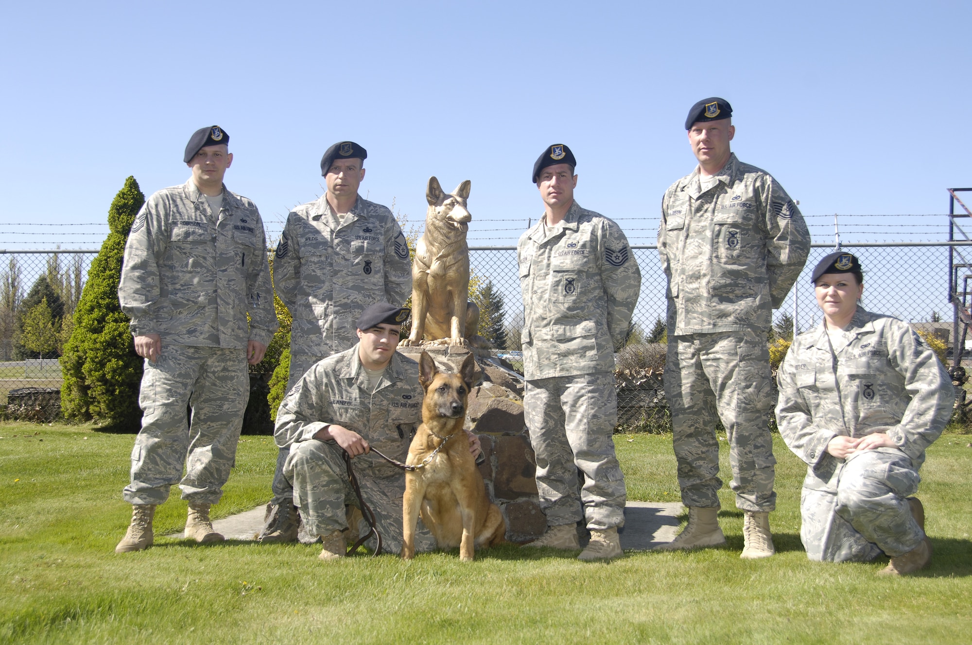 Airmen with the 92nd Security Forces Squadron military working dog section pose with Eesau in front of the working dog memorial at their training facility here on May 12, 2010.  Eesau was almost 10 years old and had been deployed to Southwest  Asia four times.  It had been rumored that Eeasu would often lull his handlers into believing he wouldn't search for hidden explosives when really he was just trying to suprise them, knowing where they were all along, according to Master Sgt. Chuck Wilds. (U.S. Air Force photo/ Staff Sgt. Chad Watkins)
