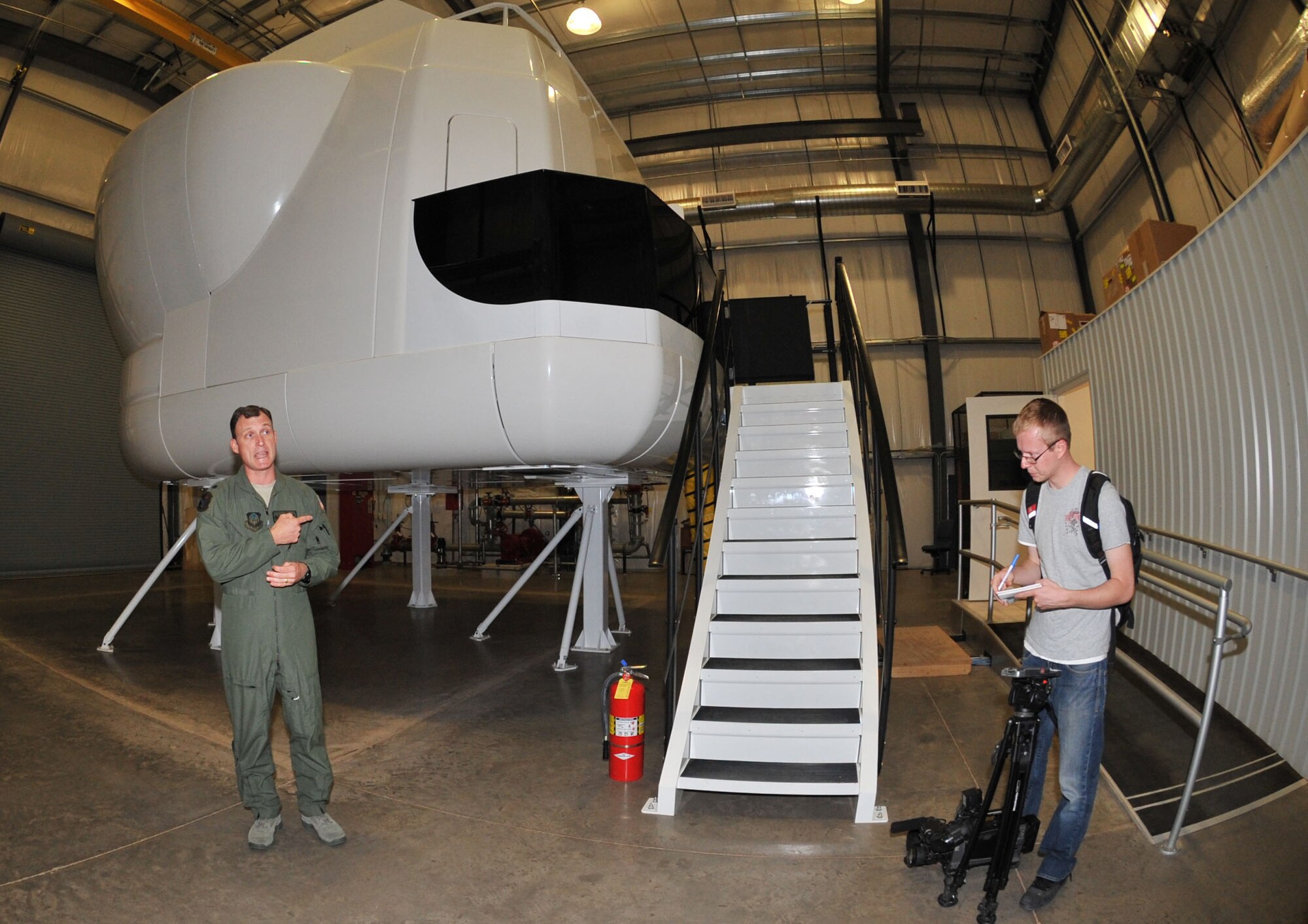 Lt. Col. Arthur Davis, Commander of the 551st Special Operations Squadron, speaks  to the media about the CV-22 simulator May 26. The $25 million simulator can be programmed to display any location and all kinds of weather. The briefing was part of a media day hosted by Cannon Air Force Base to show local area media the ongoing changes at the base.  (U.S. Air Force photo by Airman 1st Class Maynelinne De La Cruz)
