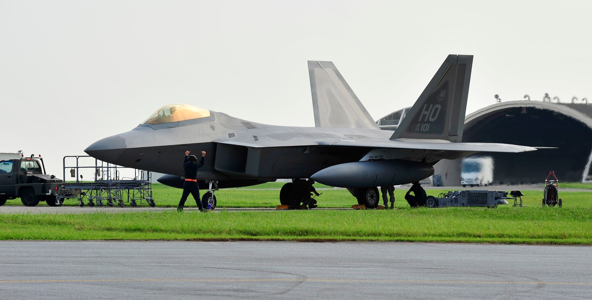 A dedicated crew chief marshals in an F-22 Raptor, May 27 at Kadena Air Base, Japan. The aircraft are deployed from Holloman Air Force Base, NM as part of an air expeditionary force rotation.  (U.S. Air Force photo/Senior Airman Amanda Grabiec)         