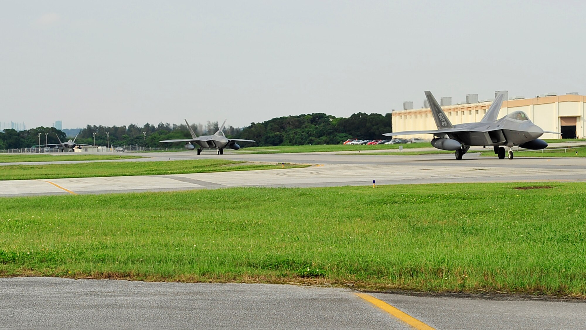 F-22 Raptors taxi down the runway of Kadena Air Base, May 27. The aircraft are deployed from Holloman Air Force Base, NM as part of an air expeditionary force rotation. (U.S. Air Force photo/Senior Airman Amanda Grabiec)  