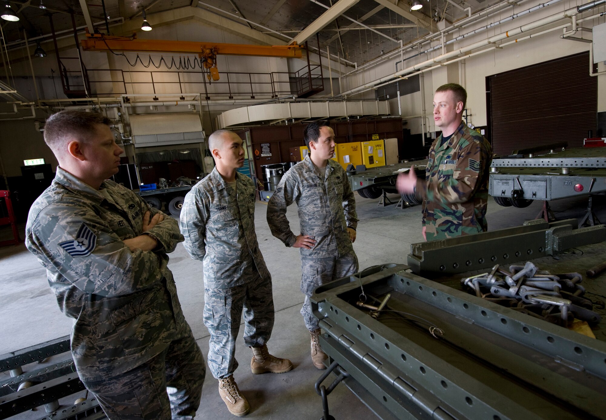 MISAWA AIR BASE, Japan -- Tech. Sgt. Scot Solheim, 35th Maintenance Squadron munitions flight munitions support equipment element chief, describes the process of inspecting and repairing trailers in the munitions support equipment element repair shop May 18. The munitions support equipment element held a four-day rapid improvement event that revamped their processes using the Air Force Smart Operations for the 21st Century model. (U.S. Air Force photo/Staff Sgt. Samuel Morse)