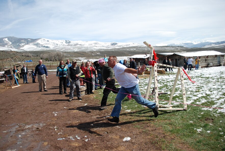 Senior Master Sgt. Michael Gettman, 302nd Security Forces Squadron superintendent of training, pulls “Cookie” across the finish line April 24 to win the wooden horse race by a hair at 4 Eagle Ranch near Vail, Colo. Air Force Reservists from the 302nd Airlift Wing and their families teamed up to build wooden horses as part of a team building exercise during a Colorado National Guard Yellow Ribbon Reintegration Program post-deployment event. YRRP was established in 2007 to assist Guard and Reserve members as they return to their daily lives after being deployed to a combat zone. Members and families who have or will deploy are welcome and encouraged to participate in future YRRP events. The 302nd AW's Airman and Family Readiness Center can provide additional information on future programs. (U.S. Air Force photo/Capt. Jody Ritchie)