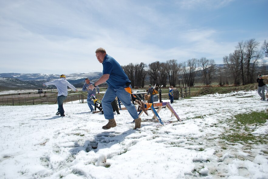 Tech. Sgt. Chris Archuleta, 302nd Aeromedical Staging Squadron aeromedical technician, gets off to a quick start April 24 as he pulls his team’s wooden race horse through the snow at 4 Eagle Ranch near Vail, Colo. Air Force Reservists from the 302nd Airlift Wing and their families teamed up to build wooden horses as part of a team building exercise during the Colorado National Guard Yellow Ribbon Reintegration Program post-deployment event. YRRP was established in 2007 to assist Guard and Reserve members as they return to their daily lives after being deployed to a combat zone. Members and families who have or will deploy are welcome and encouraged to participate in future YRRP events. The 302nd AW's Airman and Family Readiness Center can provide additional information on future programs. (U.S. Air Force photo/Capt. Jody Ritchie)