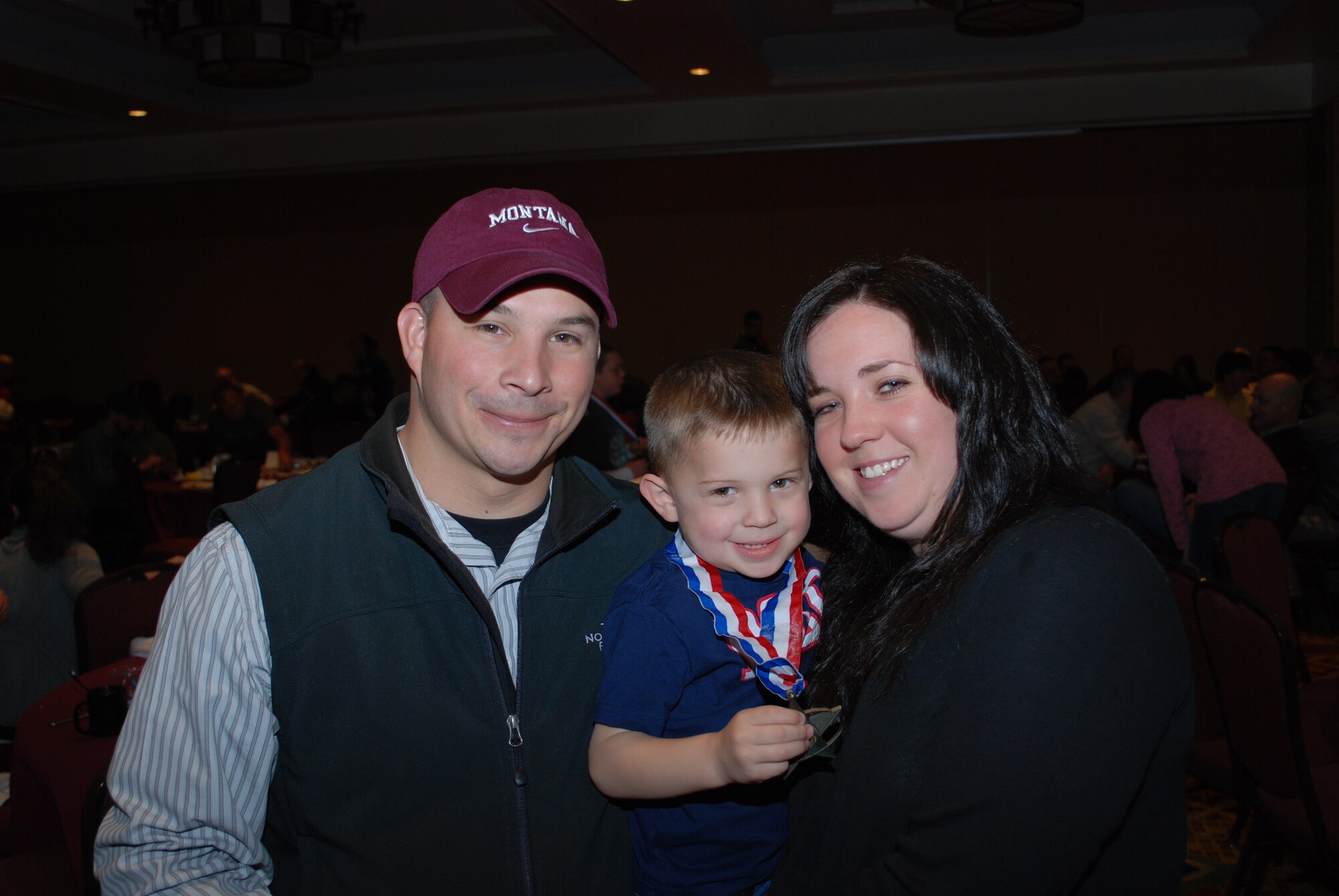 Air Force Reservist Tech. Sgt. Jody Sanchez poses with his son, Thomas, and wife, Laurie, after presenting Thomas with a medal inscribed “We Serve Too” at the April 24 Colorado National Guard Yellow Ribbon Reintegration Program post-deployment event in Vail, Colo. YRRP was established in 2007 to assist Guard and Reserve members as they return to their daily lives after being deployed to a combat zone. Members and families who have or will deploy are welcome and encouraged to participate in future YRRP events. The 302nd AW's Airman and Family Readiness Center can provide additional information on future programs. Sergeant Sanchez is the 302nd Security Forces Squadron unit deployment manager. (U.S. Air Force photo/Capt. Jody Ritchie)
