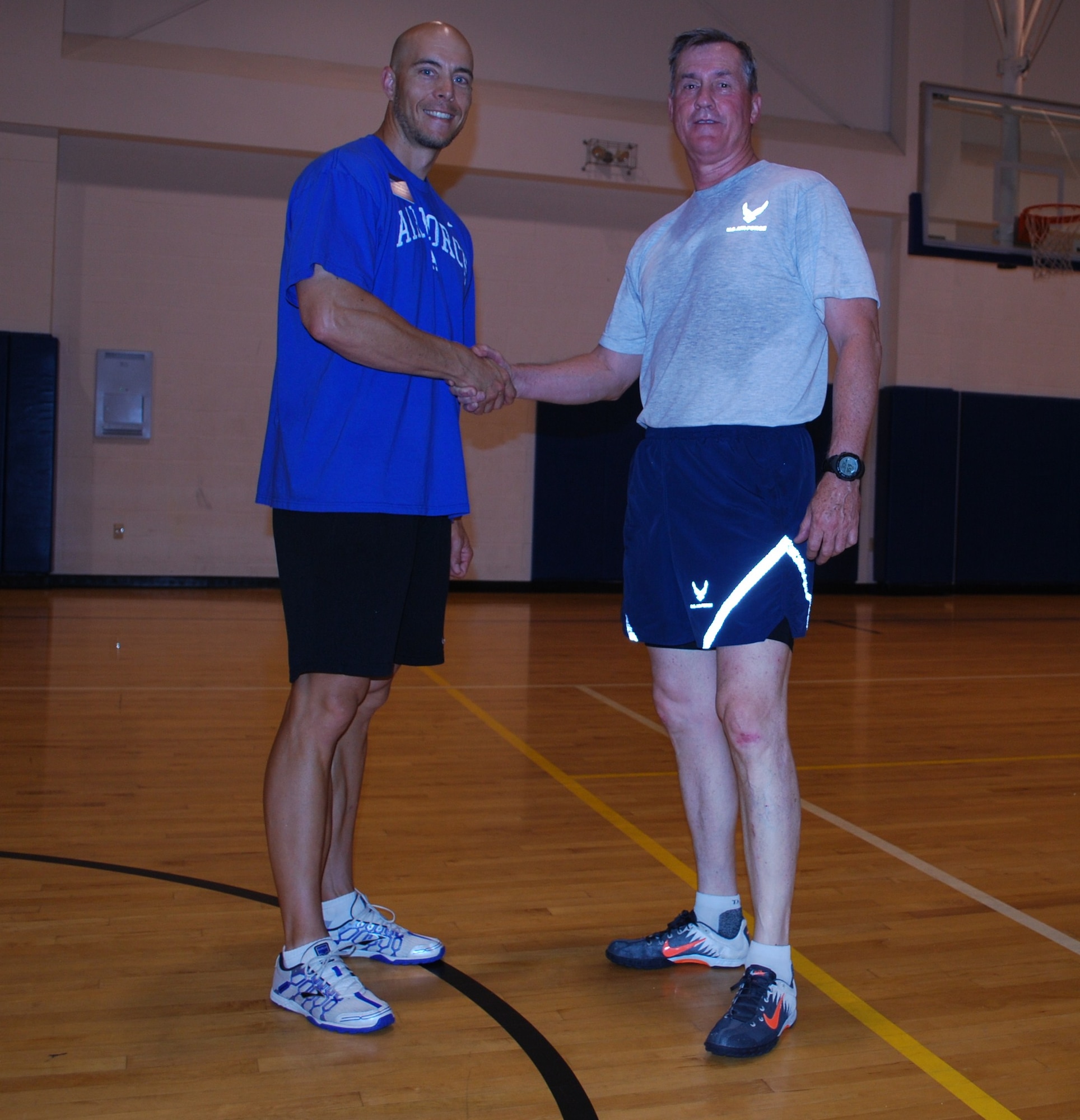 Following a wing leadership-only Combat Fit session at the Pitsenbarger Fitness Center at Sheppard Air Force Base, Texas, Brig. Gen. O.G. Mannon, 82nd Training Wing commander, coins Brent Ragsdale, Health and Wellness Center health fitness specialist, for his contributions to the Combat Fit program May 26, 2010.  Mr. Ragsdale leads the wing leadership physical fitness sessions every Wednesday morning and was a major contributor to Combat Fit getting started at Sheppard.  (U.S. Air Force photo/Tech. Sgt. Vernon Cunningham)