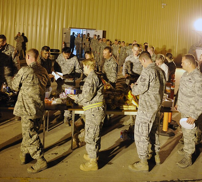 HOLLOMAN AIR FORCE BASE, N.M. -- Team Holloman members enjoy a midnight cookout at the Basic Expeditionary Airfield Resources base compound, May 22, 2010, before deploying to Kadena Air Base, Japan. First sergeants and squadron commanders from around Holloman volunteered to serve the deployers a hot meal to show their appreciation and support. (U.S. Air Force photo by Staff Sgt. Anthony Nelson Jr. / Released)