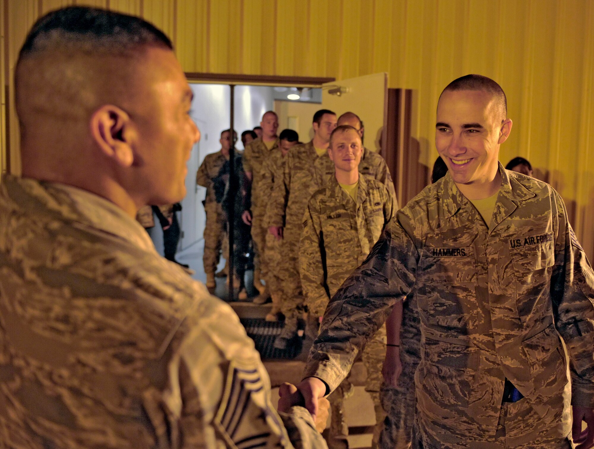 HOLLOMAN AIR FORCE BASE, N.M. -- Chief Master Sgt. Gerardo Tapia, 49th Fighter Wing command chief, speaks with Staff Sgt. Michael Hammers, 49th Maintenance Squadron, and other Airmen at the Basic Expeditionary Airfield Resources compound before they leave for their deployment to Kadena Air Base, Japan May 22, 2010. Team Holloman members deployed in support of U.S. Pacific Command's Theater Security Package. As part of continuing force posture adjustments to address worldwide requirements, the United States Department of Defense continues to deploy additional forces throughout the Western Pacific. (U.S. Air Force photo by Staff Sgt. Anthony Nelson Jr. / Released)