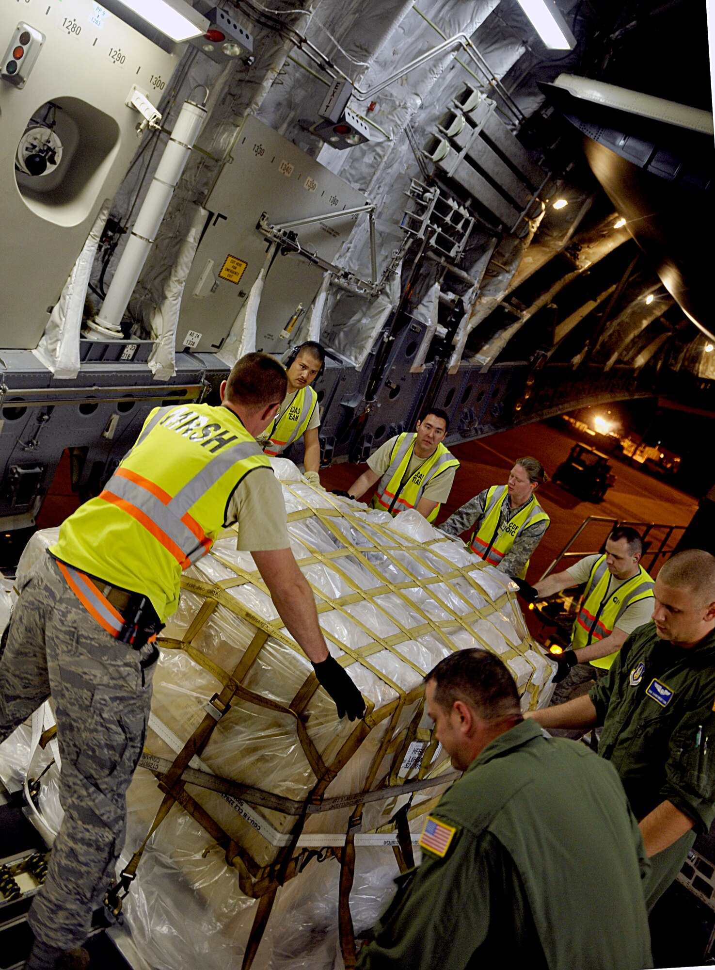 HOLLOMAN AIR FORCE BASE, N.M. -- Team Holloman members load cargo onto a C-17 Globemaster from McChord Air Force Base, Wash., in support of a recent deployment to Kadena Air Base, Japan, May 22, 2010. Team Holloman members deployed in support of U.S. Pacific Command's Theater Security Package. As part of continuing force posture adjustments to address worldwide requirements, the United States Department of Defense continues to deploy additional forces throughout the Western Pacific. (U.S. Air Force photo by Staff Sgt. Anthony Nelson Jr. / Released)
