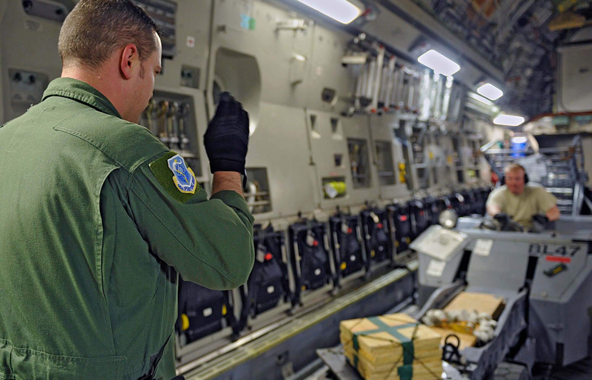 HOLLOMAN AIR FORCE BASE, N.M. -- Master Sgt. Mark Riekena, 446th Operations Support Flight load master, directs a load crew member as he positions equipment and cargo onto a C-17 Globemaster from McChord Air Force Base, Wash., May 22, 2010. The cargo was being sent in support of a deployment to Kadena Air Base, Japan, as part of U.S. Pacific Command's Theater Security Package. (U.S. Air Force photo by Staff Sgt. Anthony Nelson Jr. / Released)
