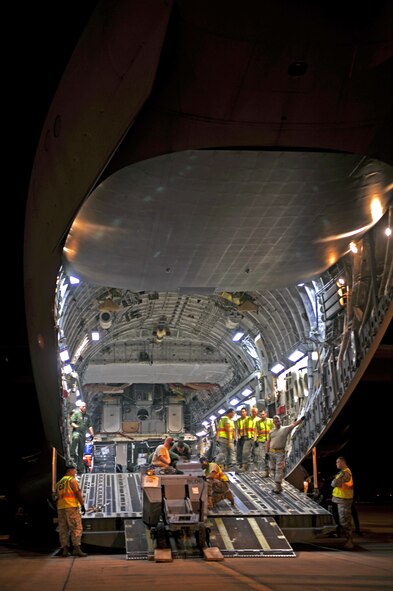 HOLLOMAN AIR FORCE BASE, N.M. -- Team Holloman members load cargo onto a C-17 Globemaster from McChord Air Force Base, Wash., in support of a recent deployment to Kadena Air Base, Japan, May 22, 2010. Team Holloman members deployed in support of U.S. Pacific Command's Theater Security Package. As part of continuing force posture adjustments to address worldwide requirements, the United States Department of Defense continues to deploy additional forces throughout the Western Pacific. (U.S. Air Force photo by Staff Sgt. Anthony Nelson Jr./ Released)