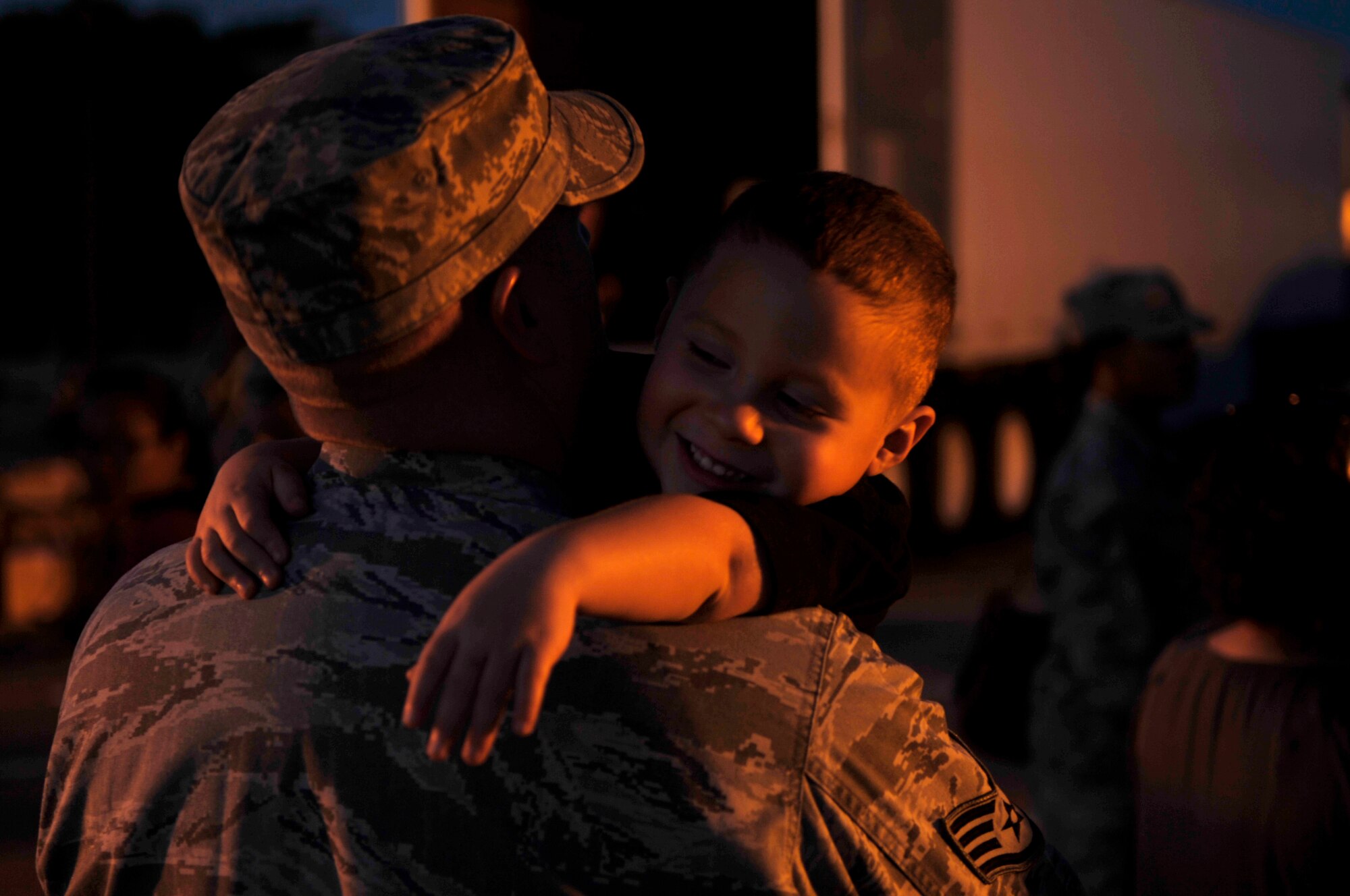 HOLLOMAN AIR FORCE BASE, N.M. -- Staff Sgt. James Warren, 49th Maintenance Squadron, hugs his son May 21, 2010, before deploying to Kadena Air Base, Japan. Twelve F-22 Raptors deployed from Holloman to Kadena AB along with approximately 250 Airmen. As part of continuing force posture adjustments to address worldwide requirements, the United States continues to deploy additional forces throughout the Western Pacific as part of U.S. Pacific Command's Theater Security Package. This is the latest example of the flexibility U.S. forces have to meet their ongoing commitments and security obligations throughout the Pacific region. (U.S. Air Force photo by Airman 1st Class Joshua Turner / Released)
