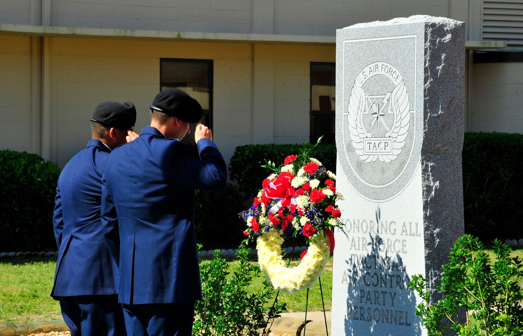 From Right to Left, Lt. Col. Roy Fatur, 10th Air Support Oeprations Squadron commander, and Chief Master Sgt. John Hansen, 10th ASOS chief enlisted manager, place a wreath in honor of Senior Airman Brad Smith, a 10th ASOS Tactical Air Control Party member, during a memorial ceremony May 26, 2010. While deployed in support of Operation Enduring Freedom, Airman Smith, a TACP assigned to the 10th Air Support Operations Squadron, was killed along with three other U.S. servicemembers when his unit encountered multiple improvised explosive devices Jan. 3, 2010. (DoD photo by U.S. Air Force Senior Airman Sheila Devera)