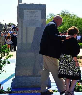 from left to right, Gary and Paula Smith, parents of Senior Airman Brad Smith, return to their seats after viewing the Tactical Air Control Party Memorial Wall after their sons name was revealed during a memorial ceremony, May 26, 2010.  While deployed in support of Operation Enduring Freedom, Airman Smith, a TACP assigned to the 10th Air Support Operations Squadron, was killed along with three other U.S. servicemembers when his unit encountered multiple improvised explosive devices Jan. 3, 2010. (DoD photo by U.S. Air Force Senior Airman Sheila Devera)
