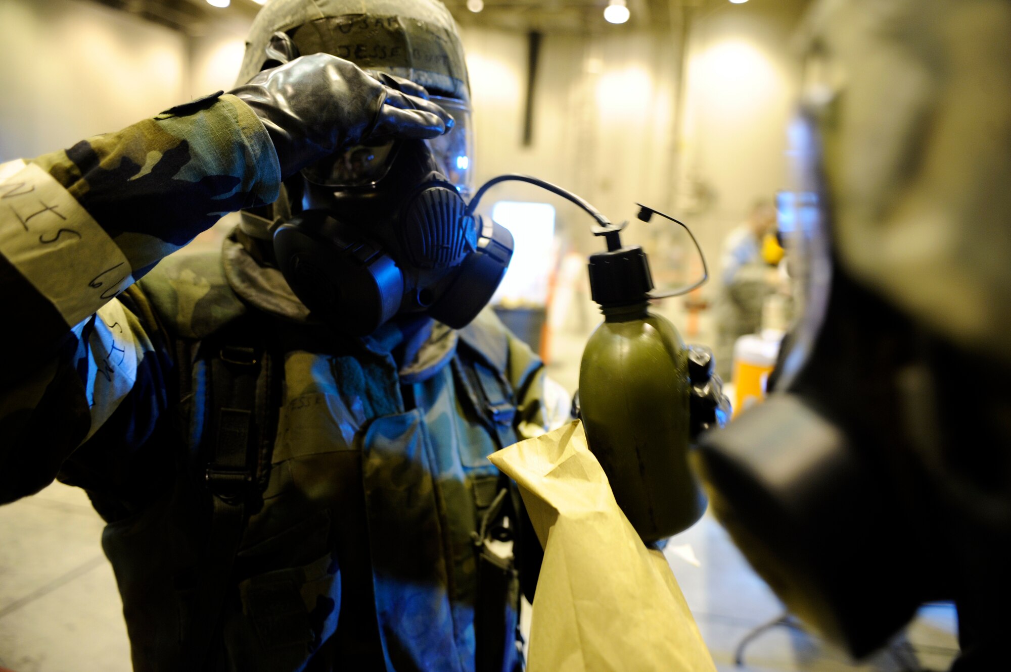 Airman 1st Class Jesse Burton decontaminates his canteen as he prepares to take a drink May 21, 2010, Eielson Air Force Base, Alaska. This exercise was part of the ability to survive and operate portion of the May operational readiness inspection. Airman Burton is assigned to the 354th Civil Engineer Squadron. (U.S. Air Force photo/Airman 1st Class Willard E. Grande II)