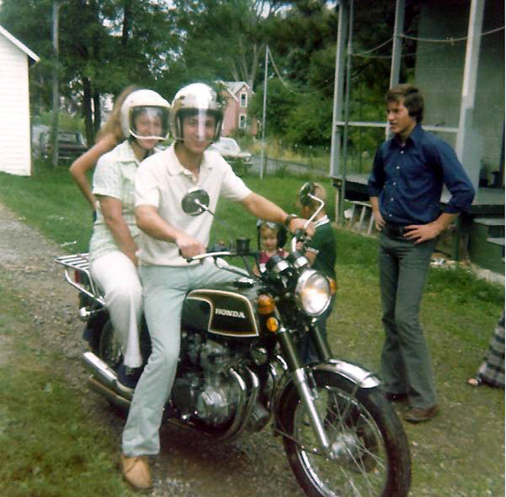 Eric Crabtree prepares to take his mother, Ruth, for a ride on his motorcycle near their Cassadaga, N.Y. home in 1974 while his younger brother, Scott looks on.  (Courtesy photo)