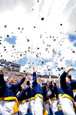 Newly commissioned second lieutenants throw their hats into the air to celebrate graduation in Falcon Stadium at the Air Force Academy May 26, 2010. The Thunderbirds U.S. Air Force Air Demonstration Team performed at the conclusion of the ceremony. (U.S. Air Force photo/Bill Evans)
